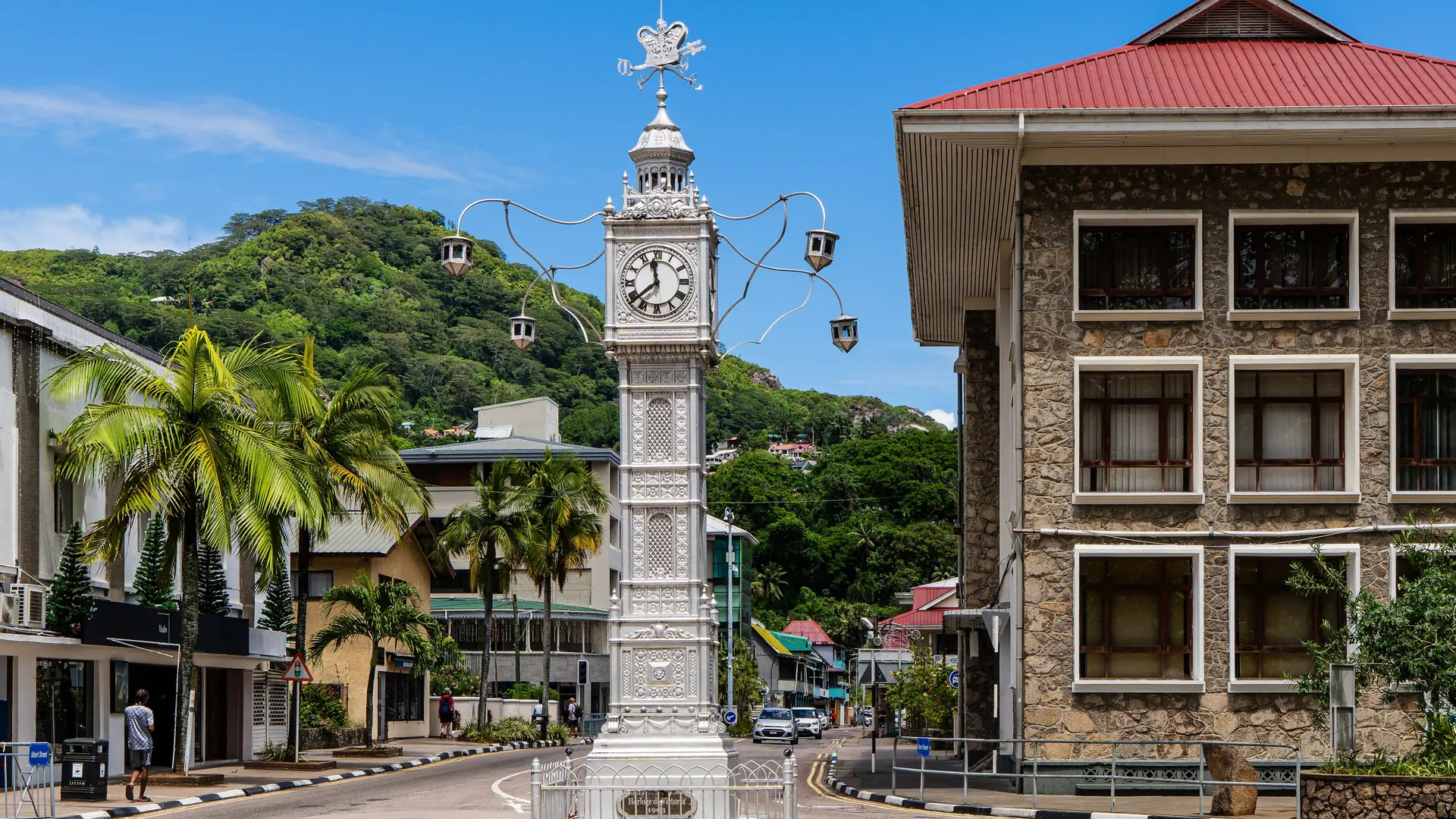 Victoria Clock Tower above a sunny central street and historic buildings on Mahé