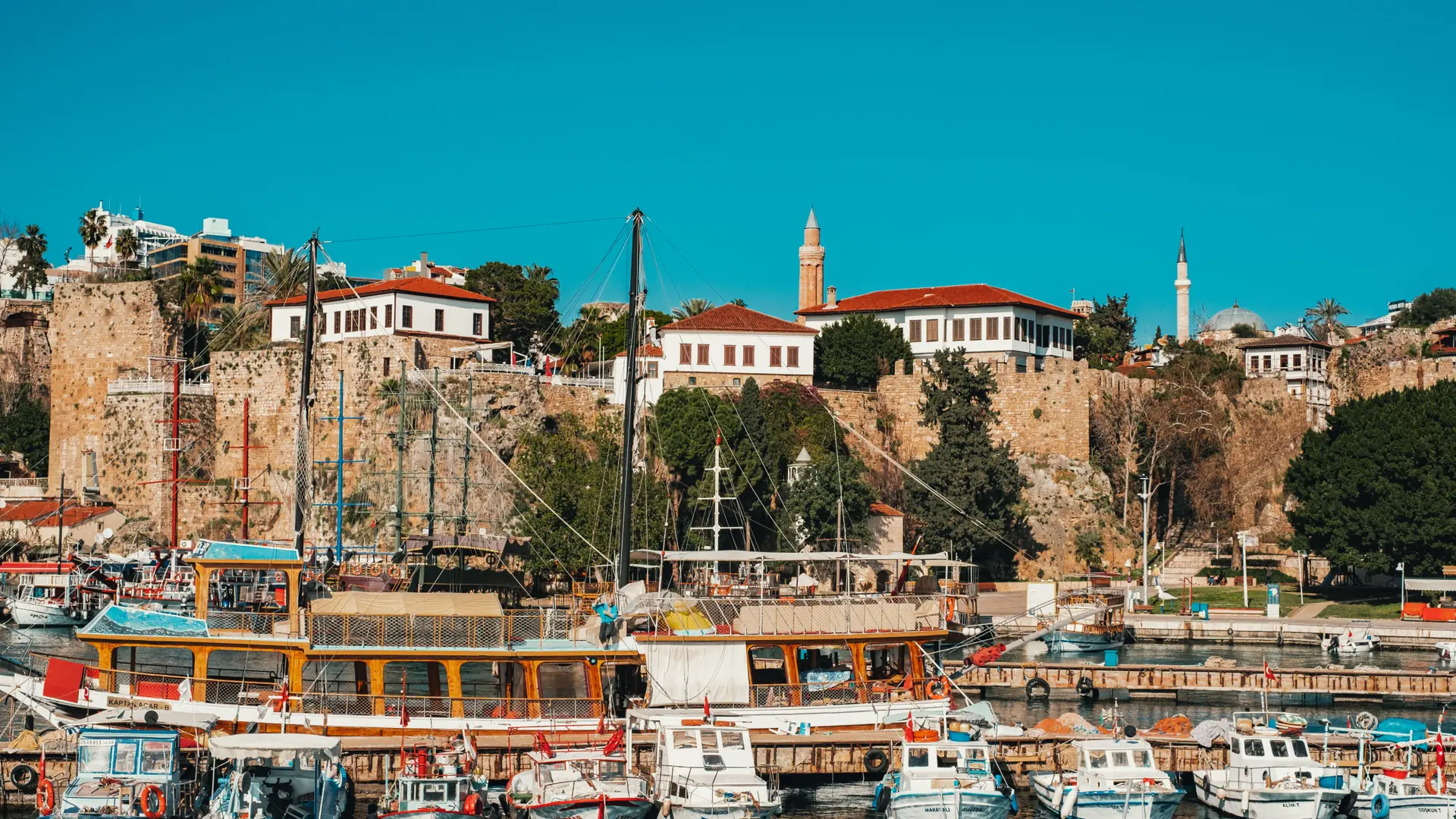 Antalya old harbour, Kaleiçi walls and turquoise Mediterranean under clear sunlight