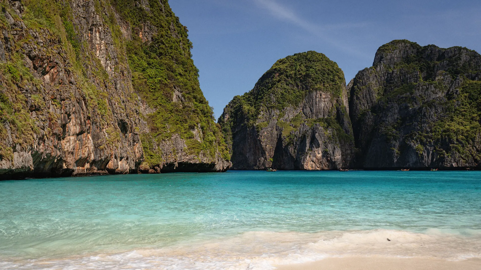 Maya Bay's pale sand and turquoise water framed by steep limestone walls