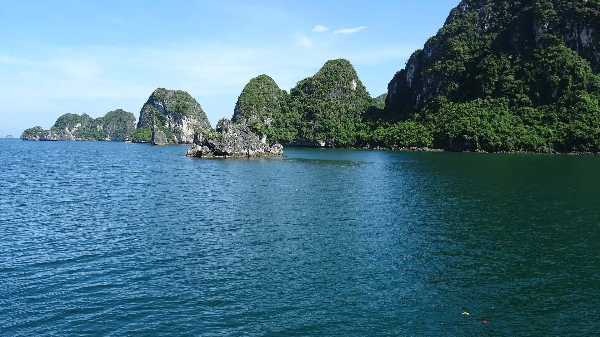 Wooded limestone towers rising from Ha Long water