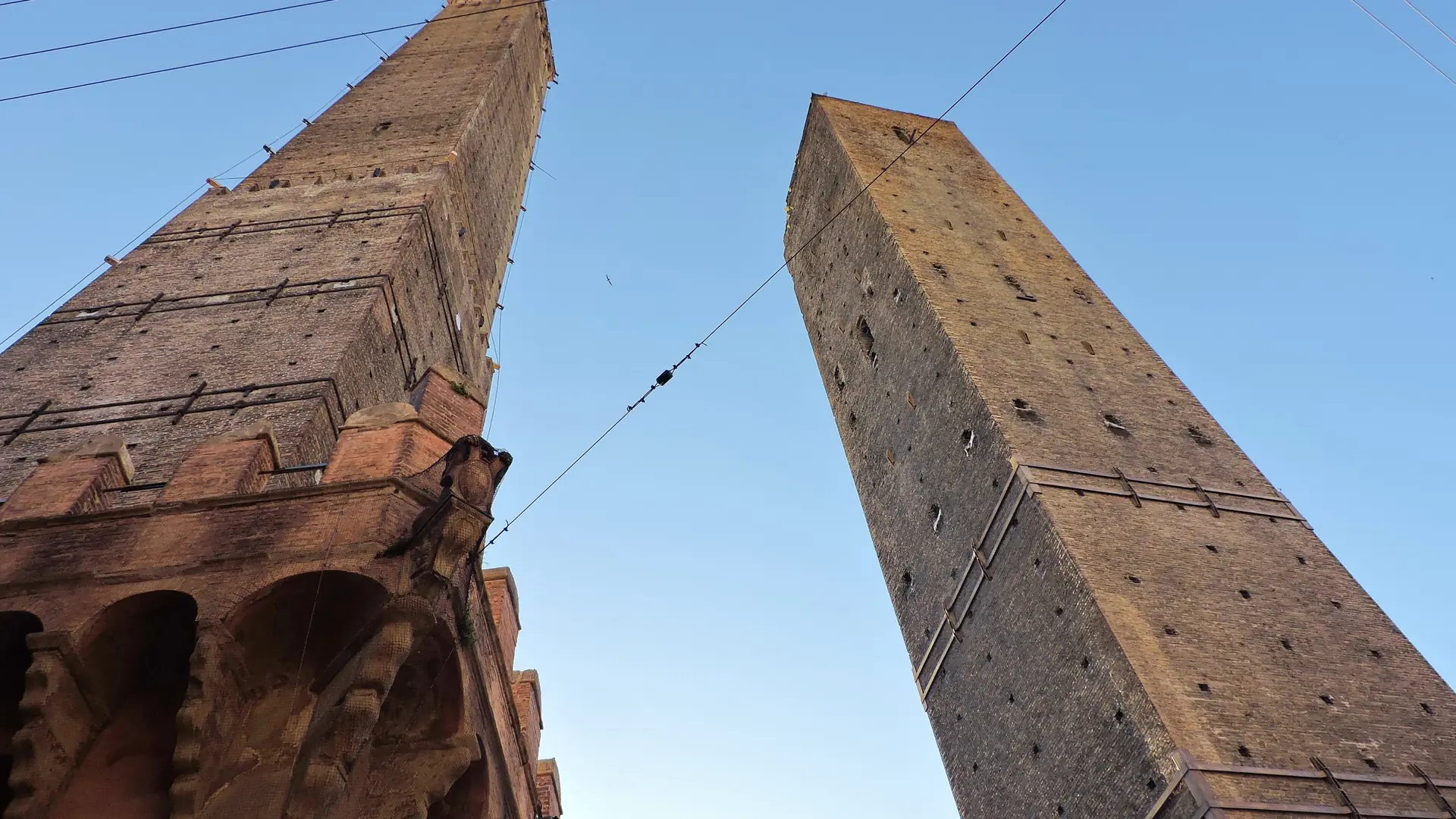 Bologna's Two Towers, Asinelli and Garisenda, rising against a clear blue sky