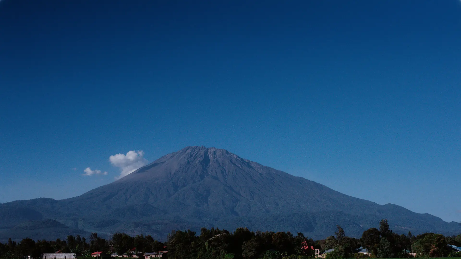 Mount Meru under a bright blue sky near Arusha, Tanzania