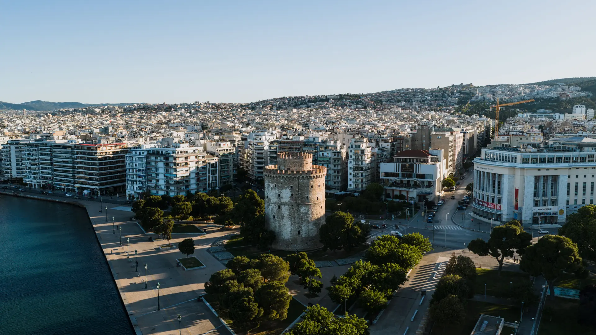 The White Tower beside Thessaloniki's waterfront and city centre in clear daylight