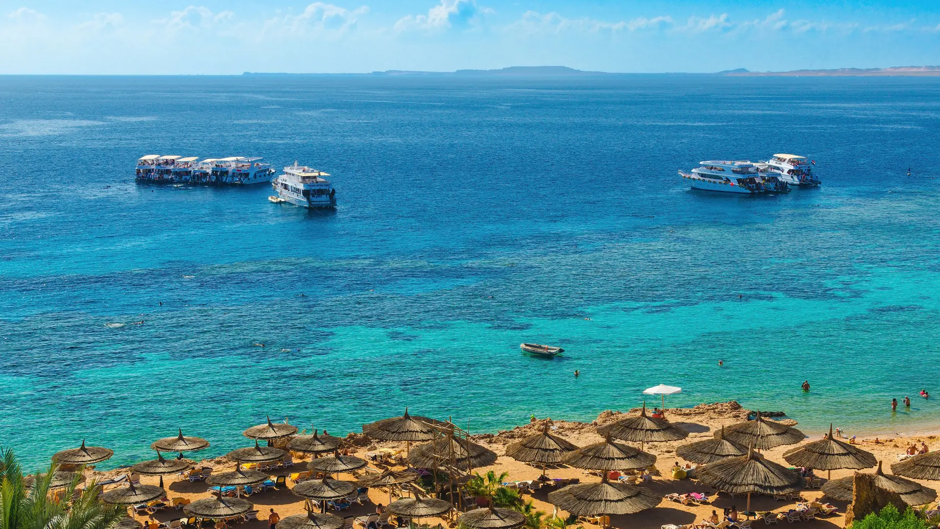 Turquoise reef water and beach at Ras Um Sid Bay, Sharm El-Sheikh