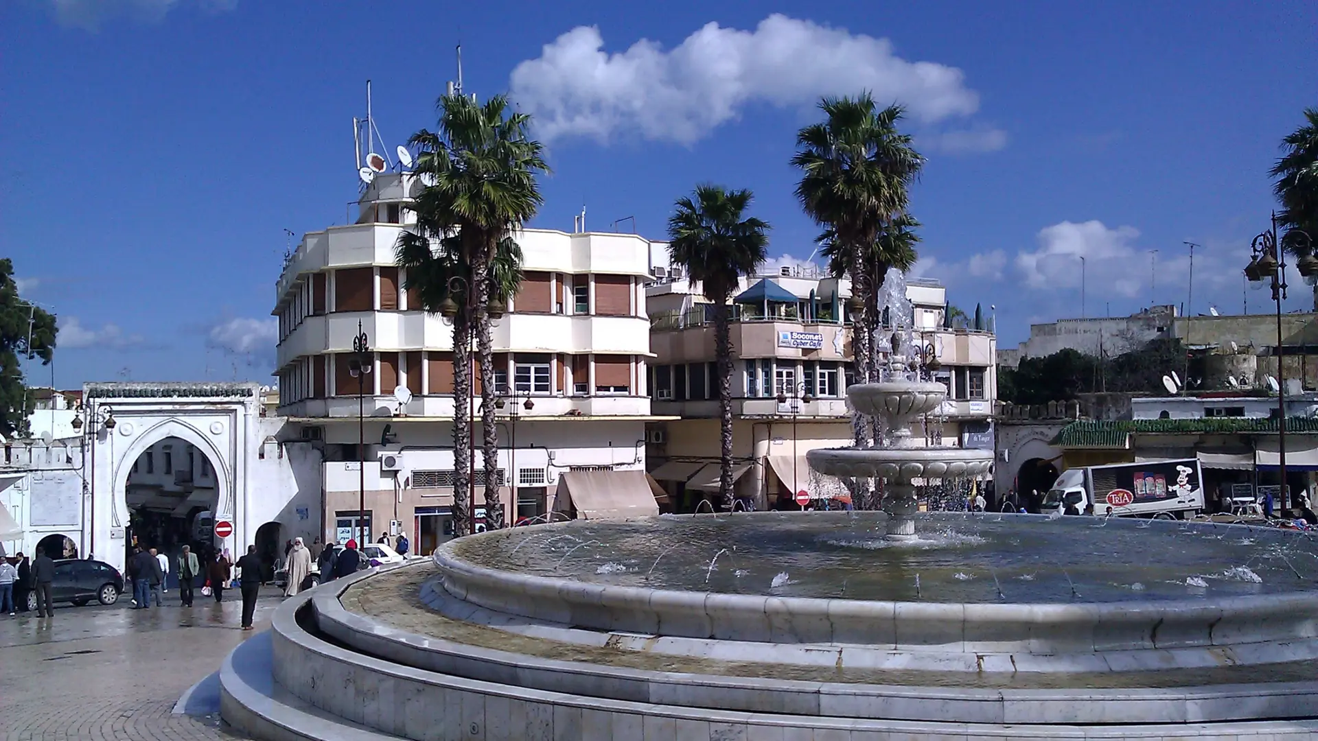 Grand Socco fountain and palms beneath a blue Tangier sky
