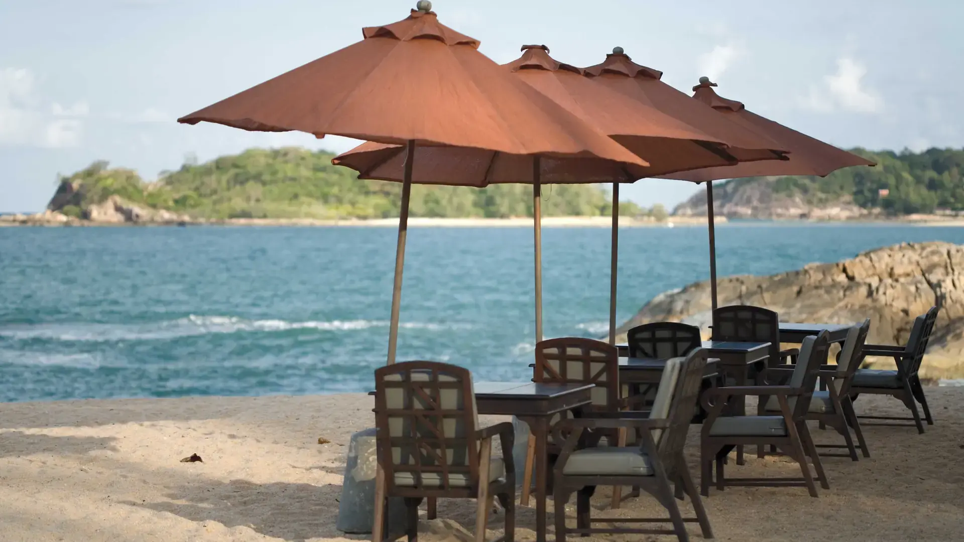 Beach parasols and loungers beside the sea on wider Koh Samui