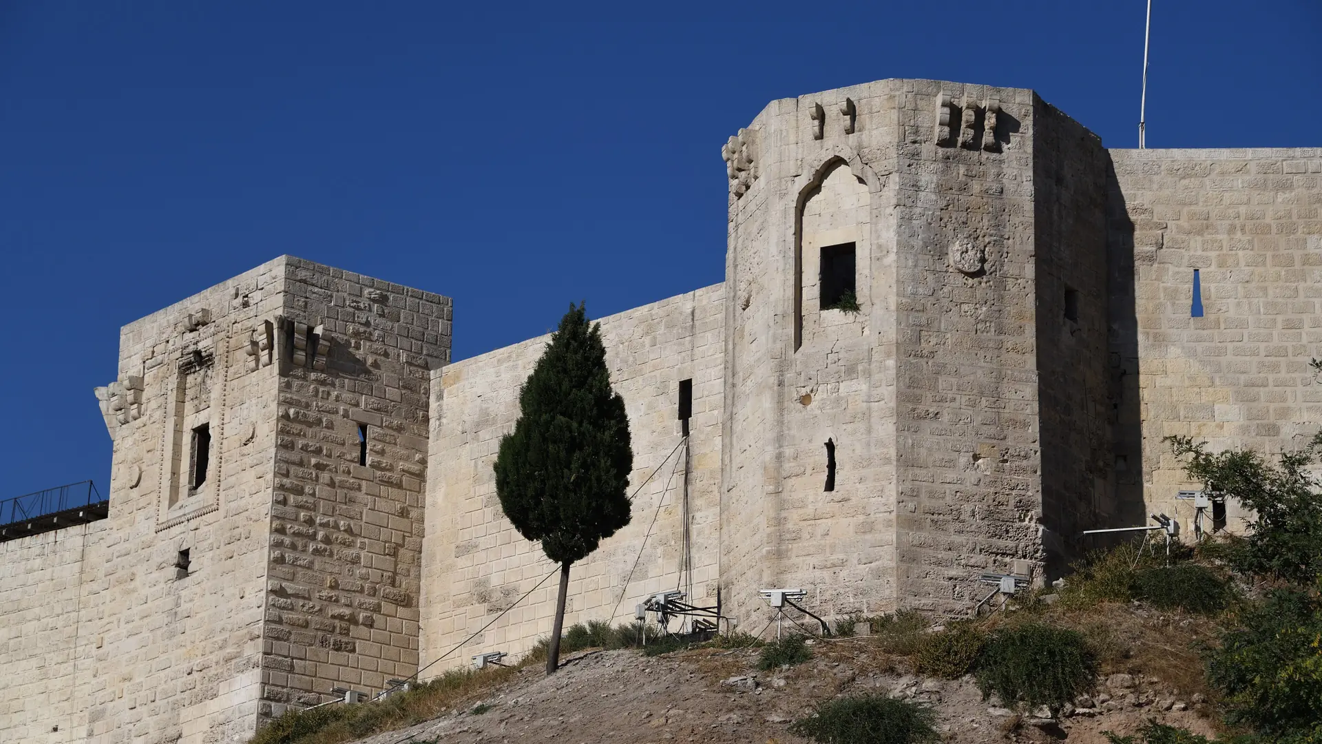 Gaziantep Castle towers against a cloudless blue sky