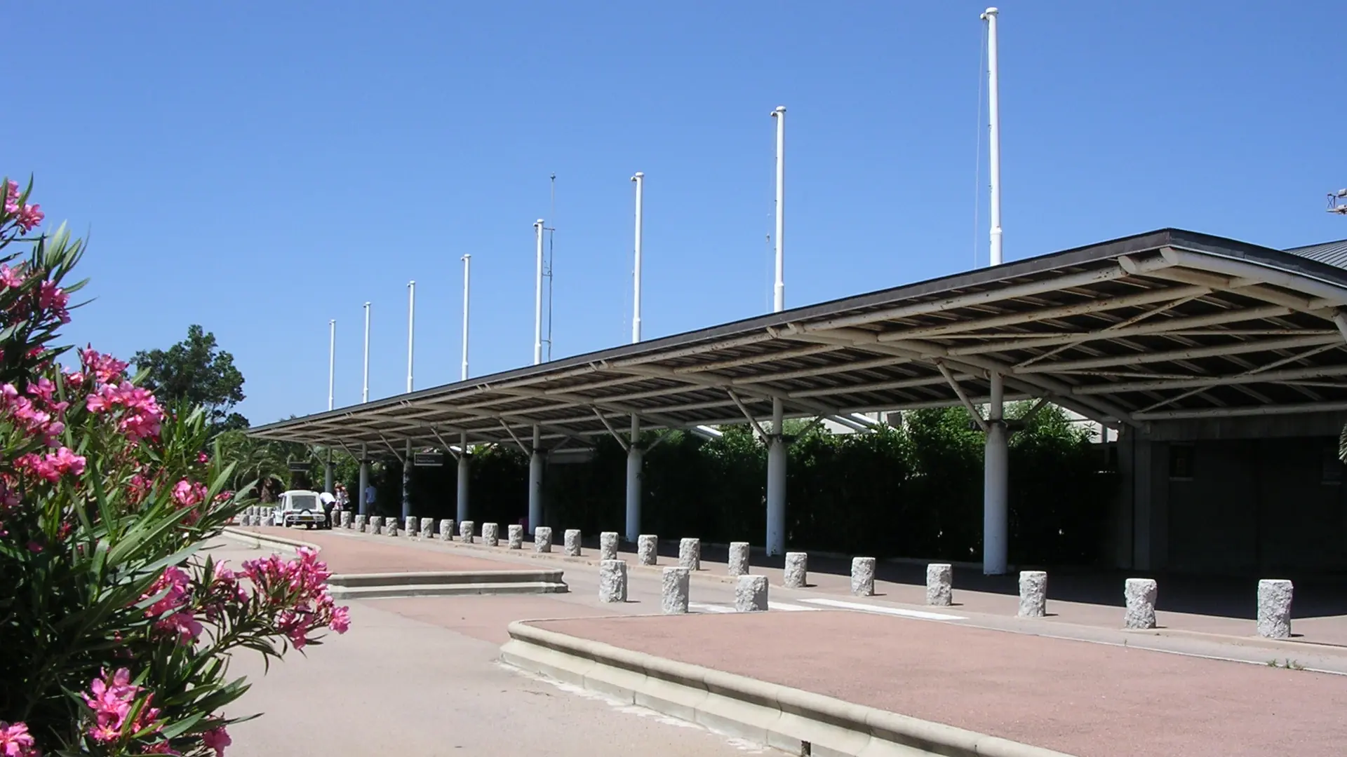 The covered terminal approach at Figari South Corsica Airport on a sunny day