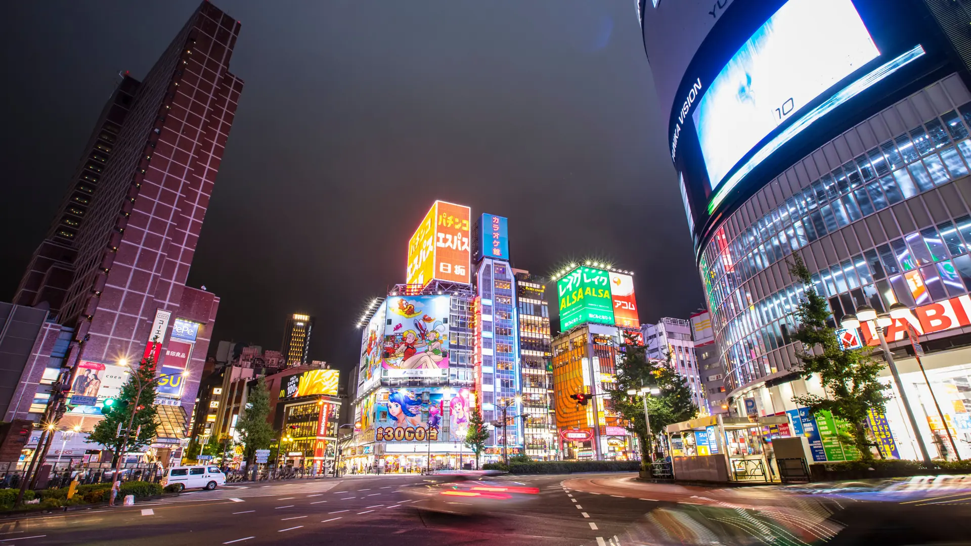 Shinjuku's neon towers and busy junction glowing vividly after dark