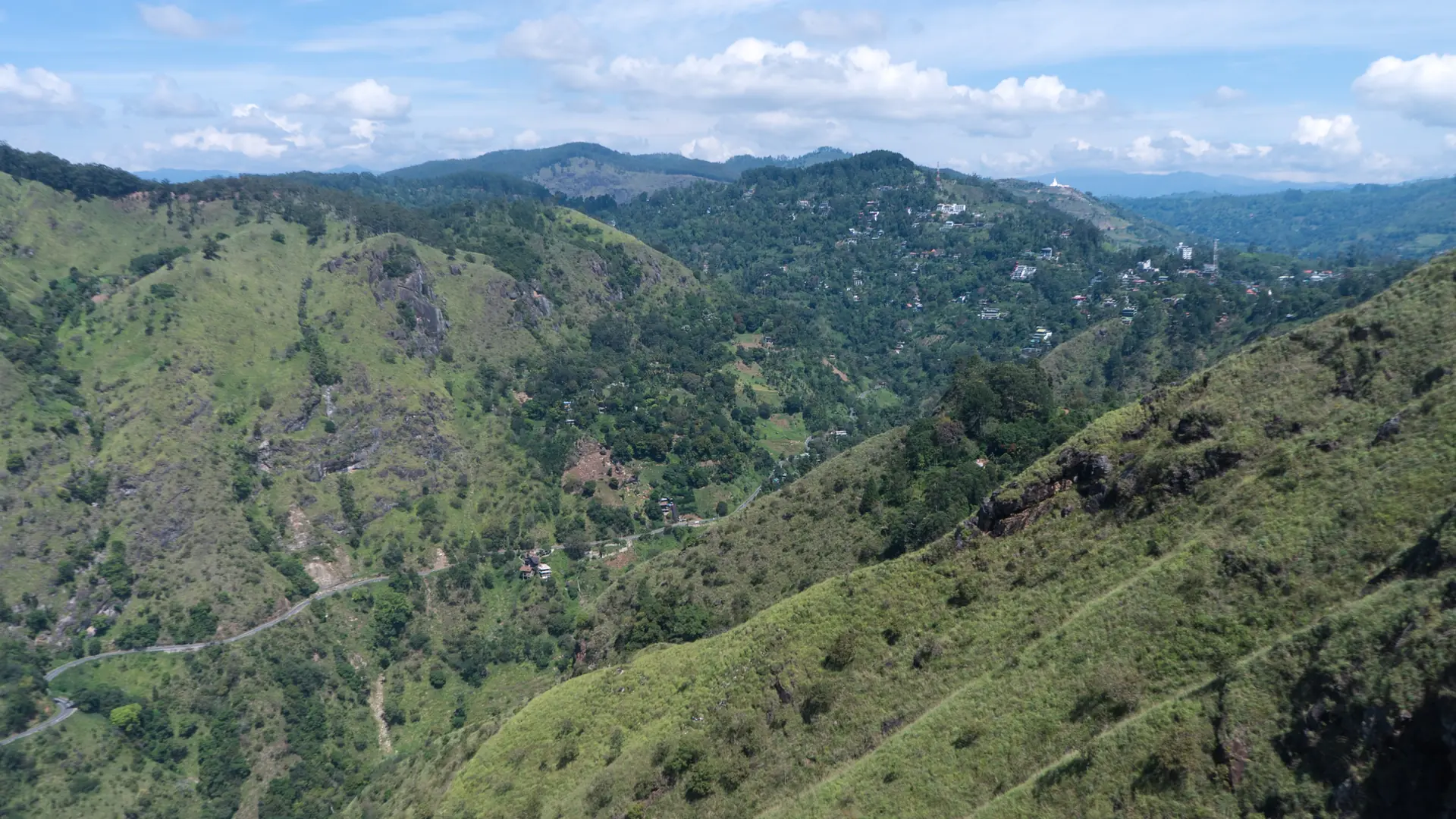 Green hills around Ella viewed from Little Adam's Peak under a blue sky