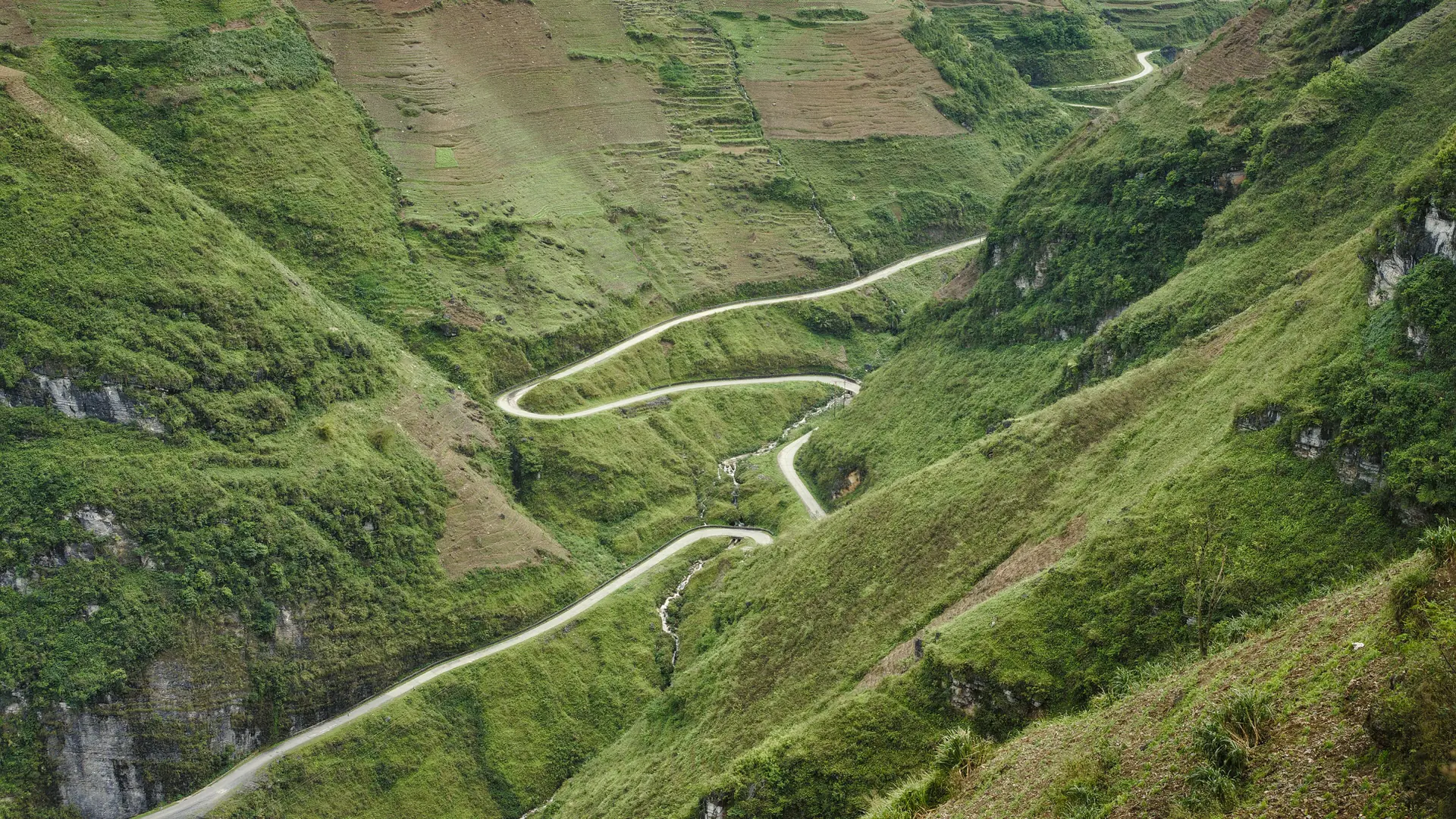 Mountain road and green slopes in the Ha Giang region
