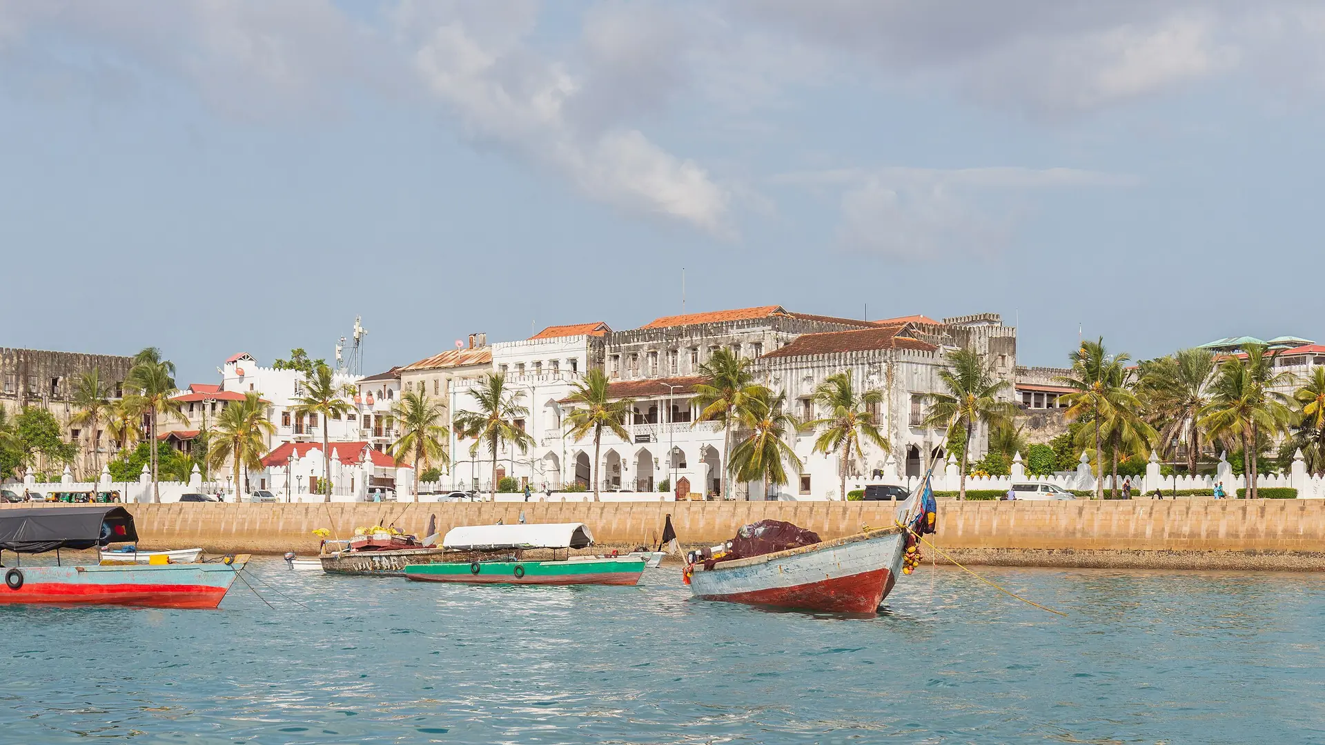 Fishing boats before Stone Town’s palm-lined historic waterfront in Zanzibar City