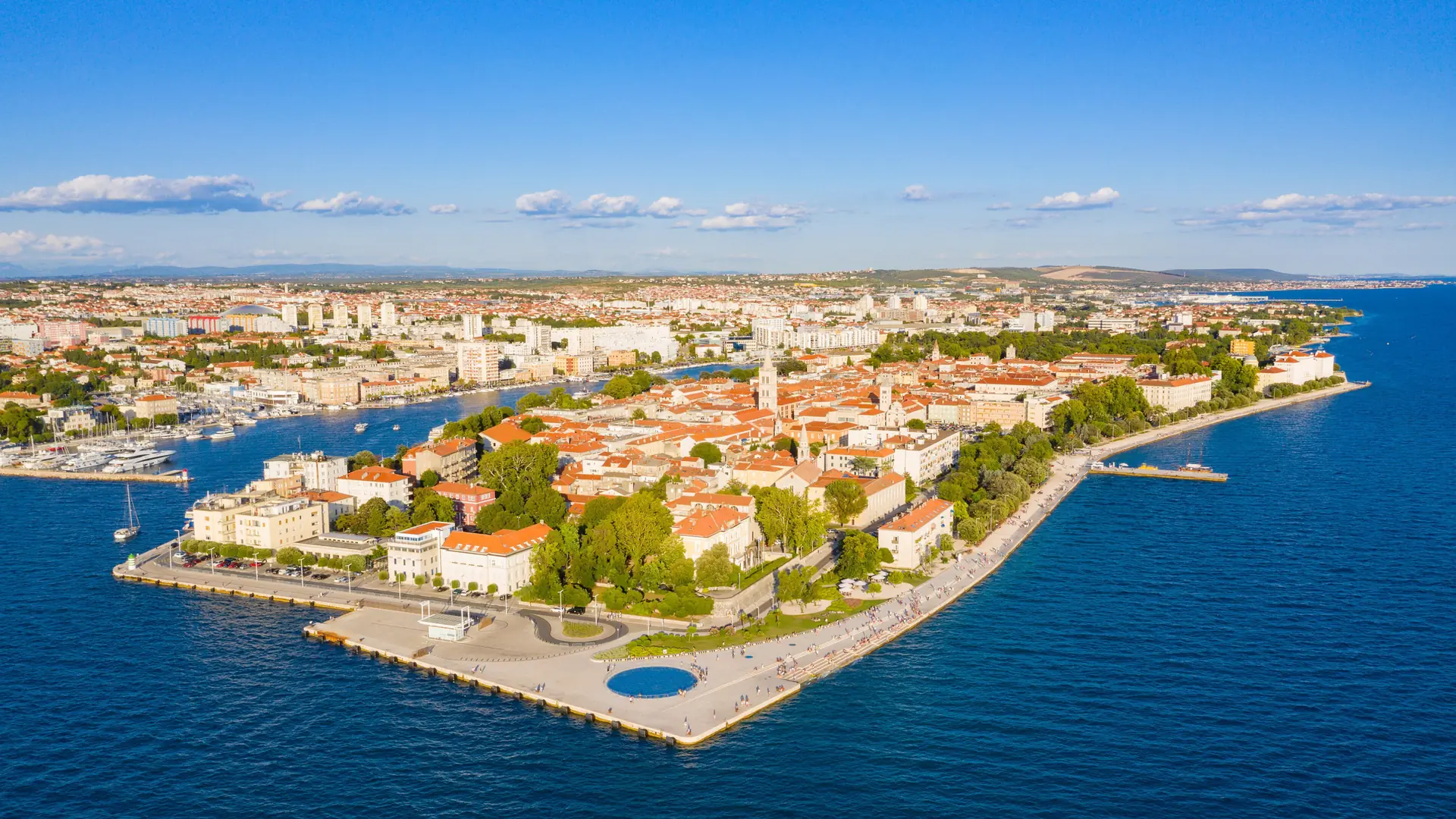An aerial view of Zadar's old town peninsula surrounded by the bright blue Adriatic