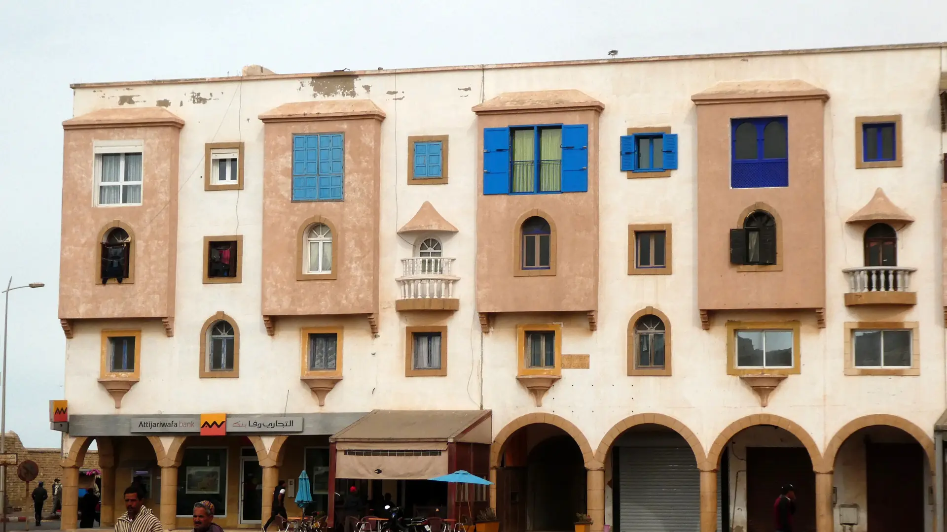 Arcaded buildings and blue windows in Essaouira’s Jewish quarter in daylight