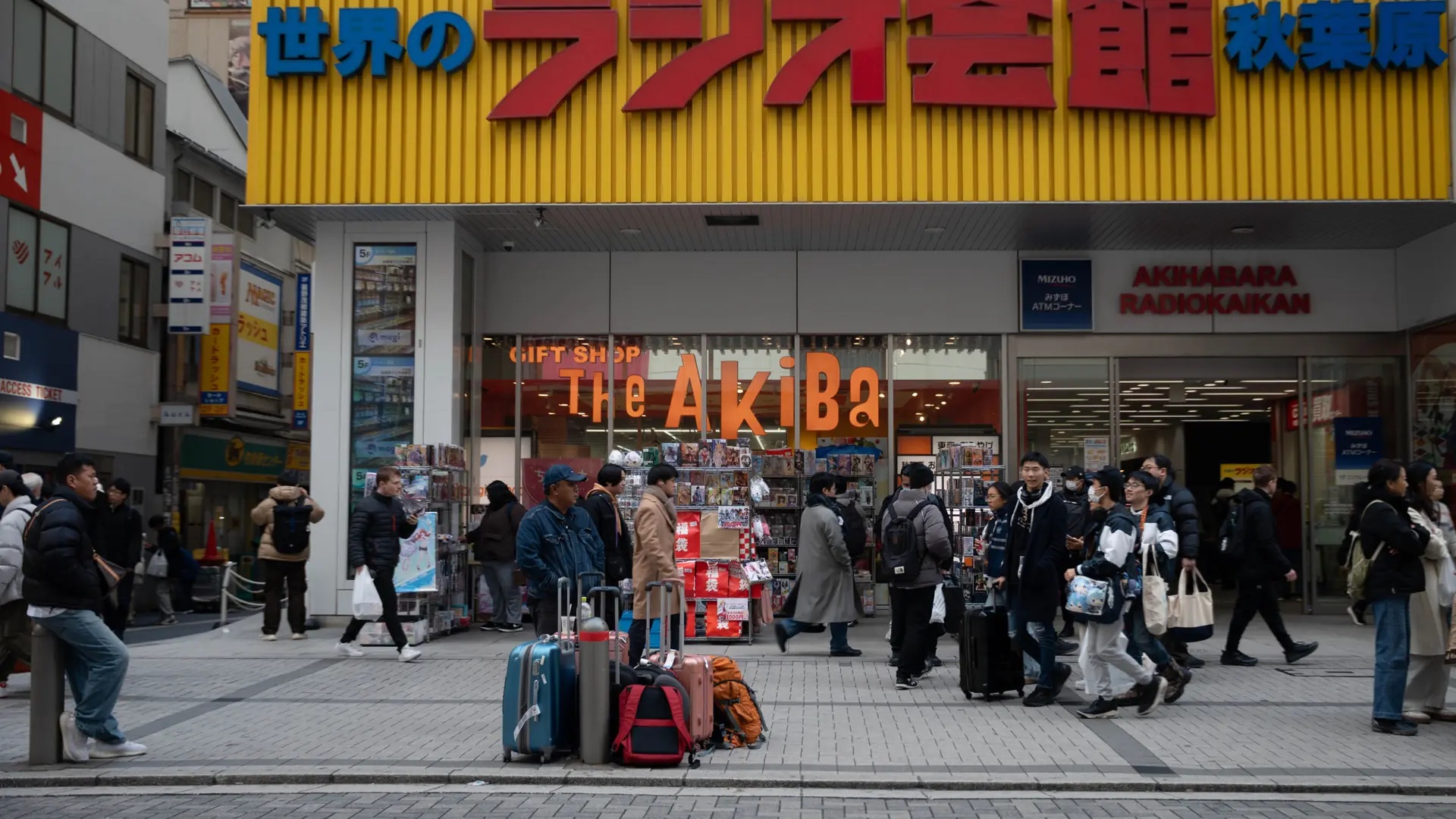 Akihabara Radio Kaikan's yellow facade and lively electronics district in daylight