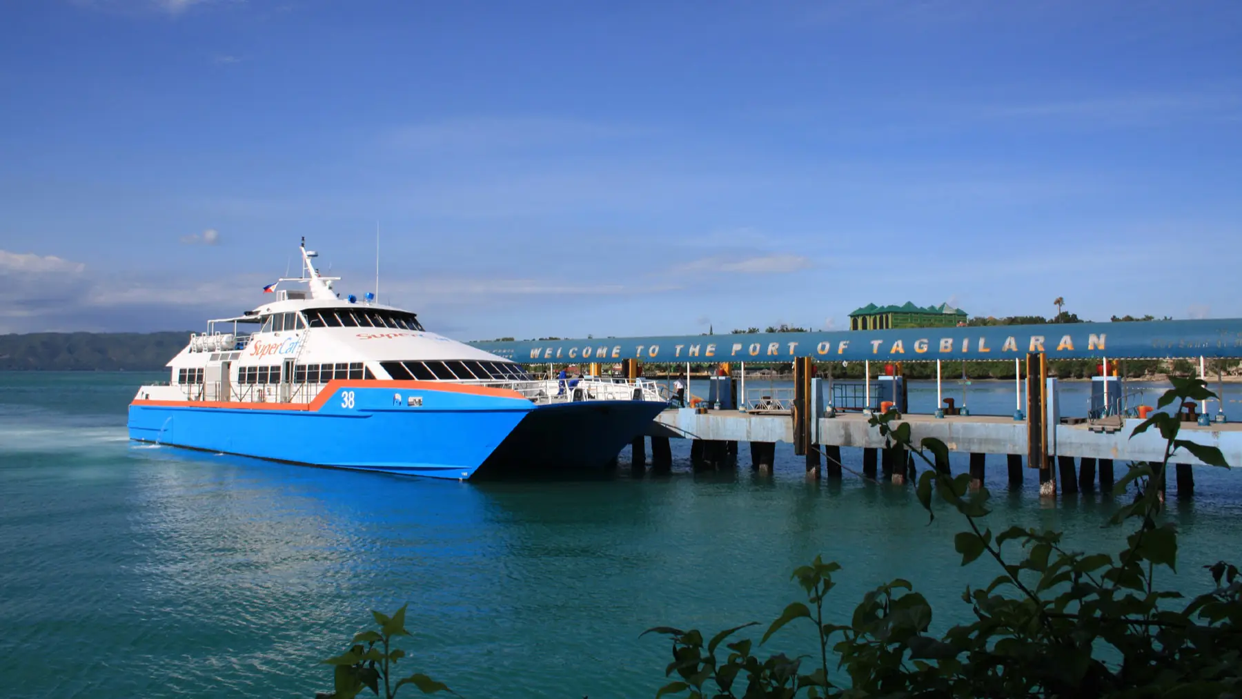 A fast ferry berthed at the Port of Tagbilaran under a clear blue Bohol sky