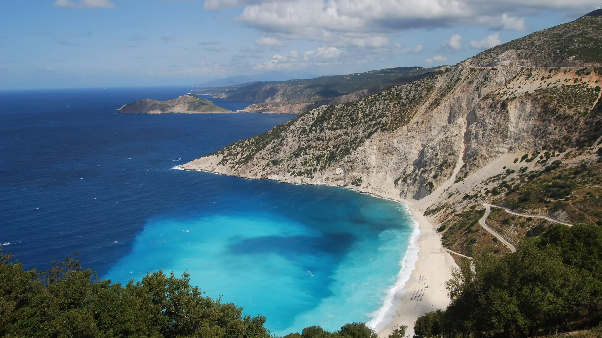Myrtos Beach curving beneath white cliffs and vivid turquoise water on Kefalonia