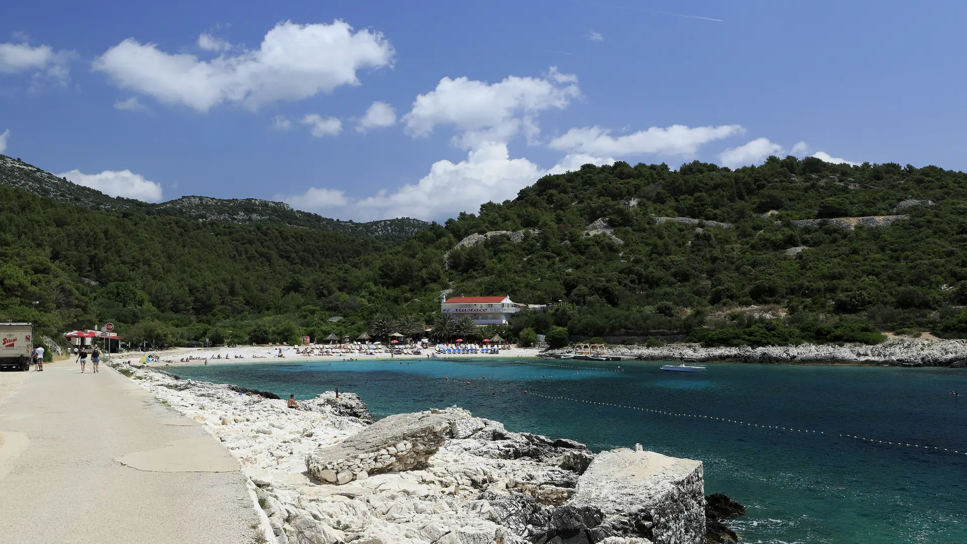 The pebble shore and clear water of Pokonji Dol bay near Hvar Town