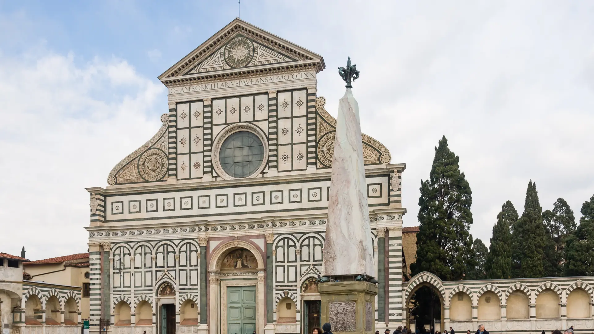 bright Florence street near Santa Maria Novella church with pale stone façades and pedestrians