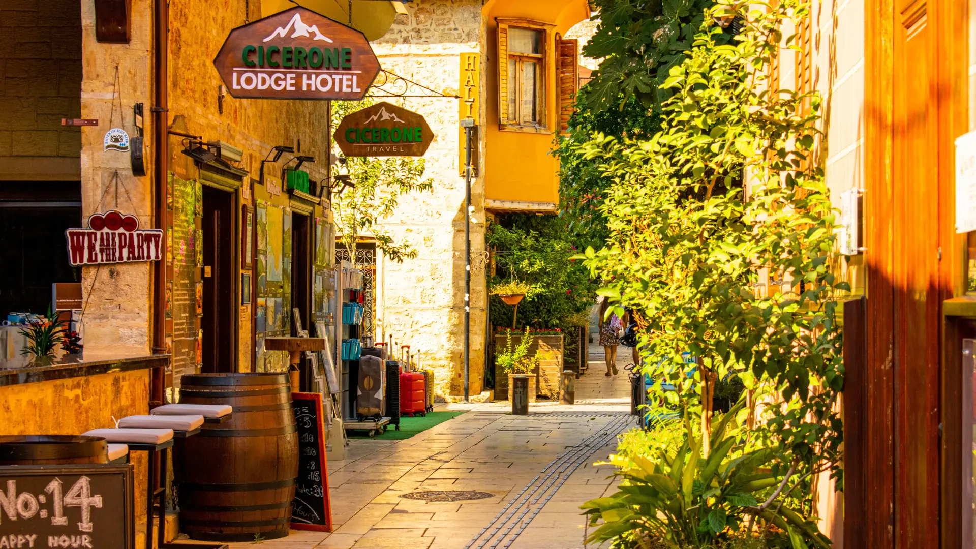 Sunlit Ottoman houses and stone lanes descending through Kaleici toward Antalya old harbour