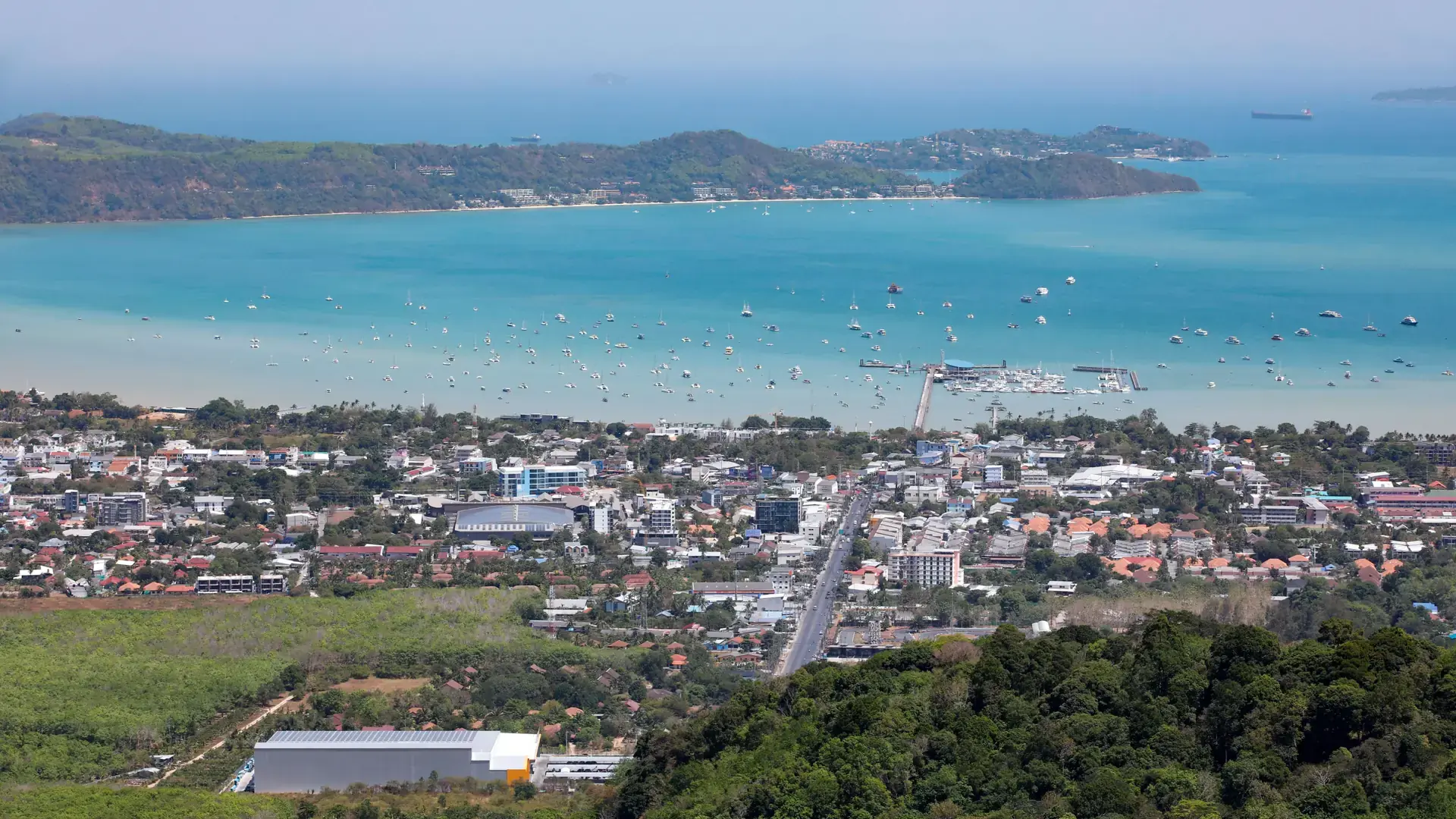 Chalong town, its long pier and broad bay seen from the hillside, a wider Phuket scene