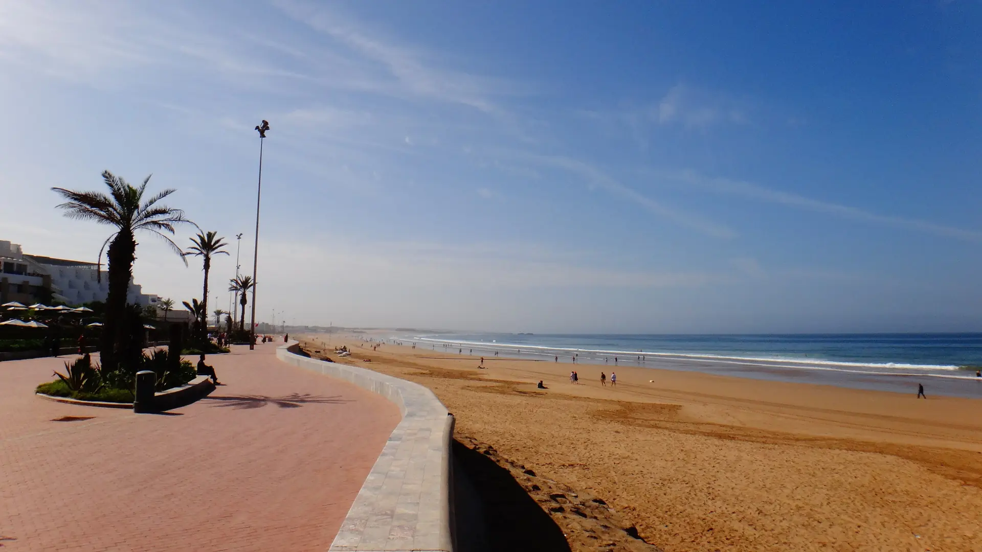 Sunny beach promenade and Atlantic shoreline in central Agadir
