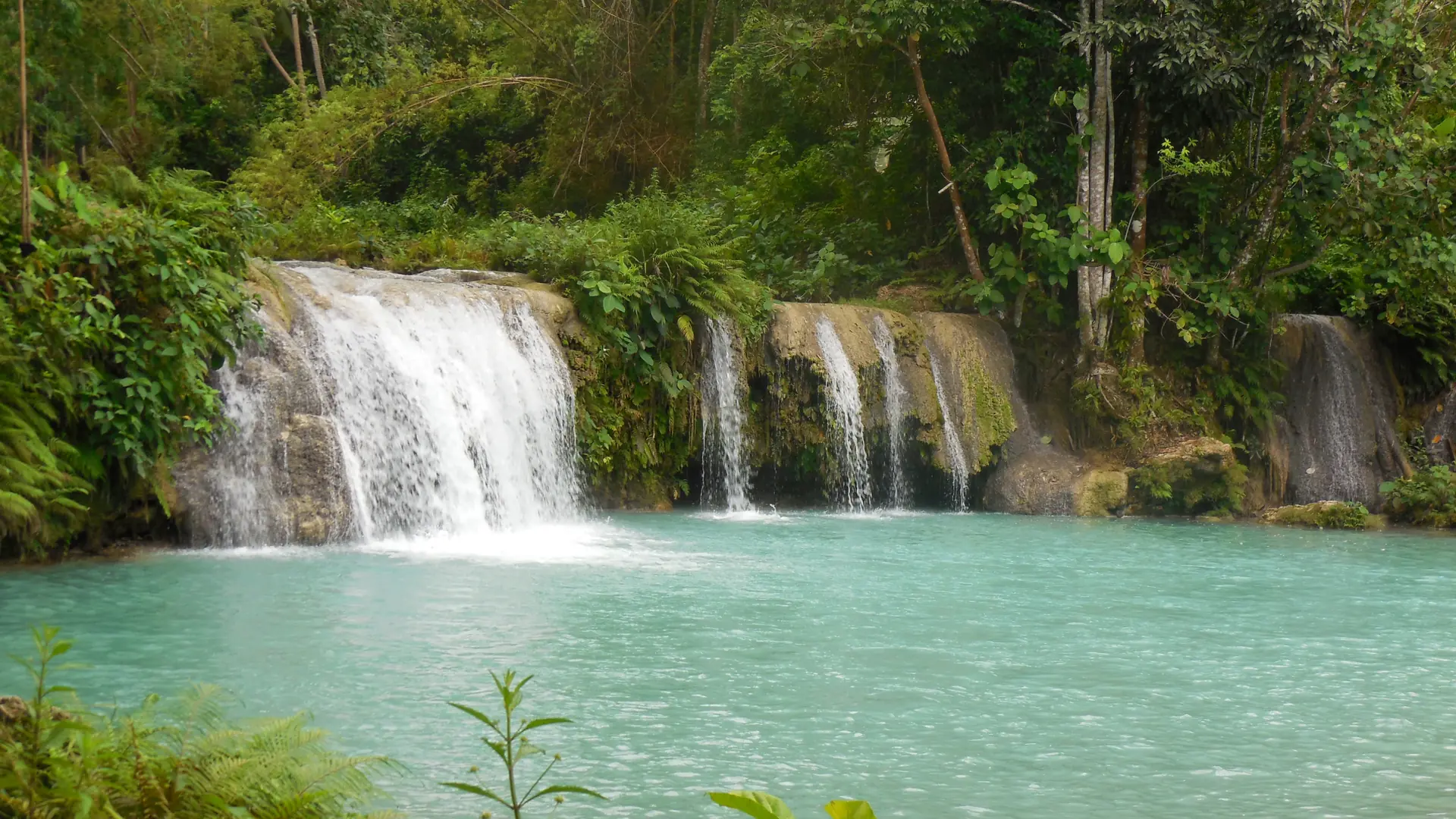 Turquoise pools and small cascades at Cambugahay Falls in Lazi, Siquijor