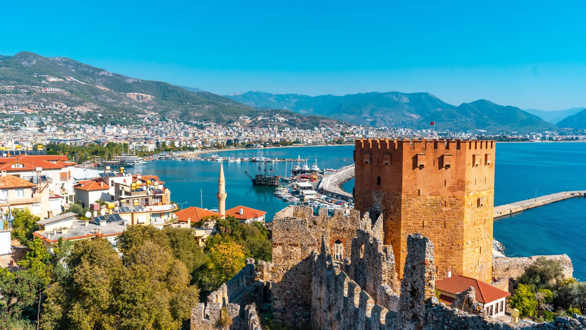 Red Tower and Alanya harbour backed by the castle peninsula