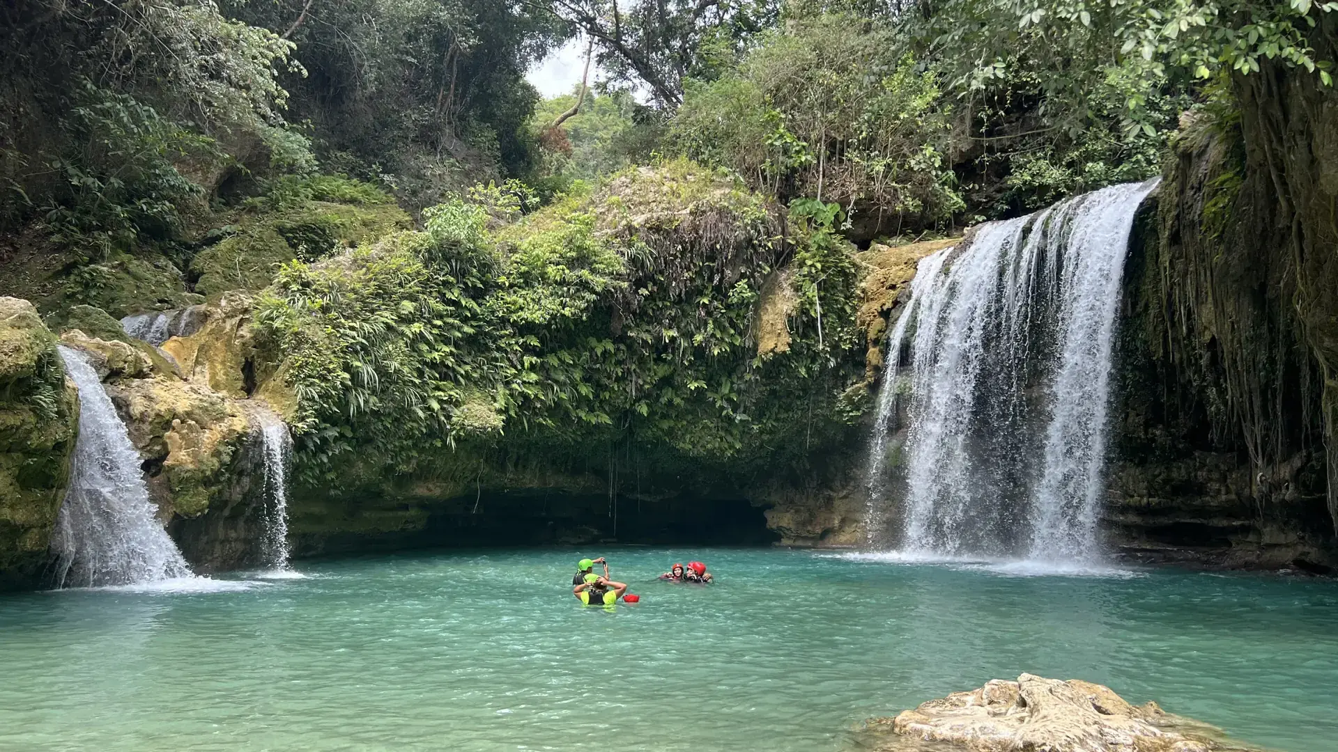 Kawasan Falls tumbling into a turquoise pool ringed by jungle in Badian, Cebu