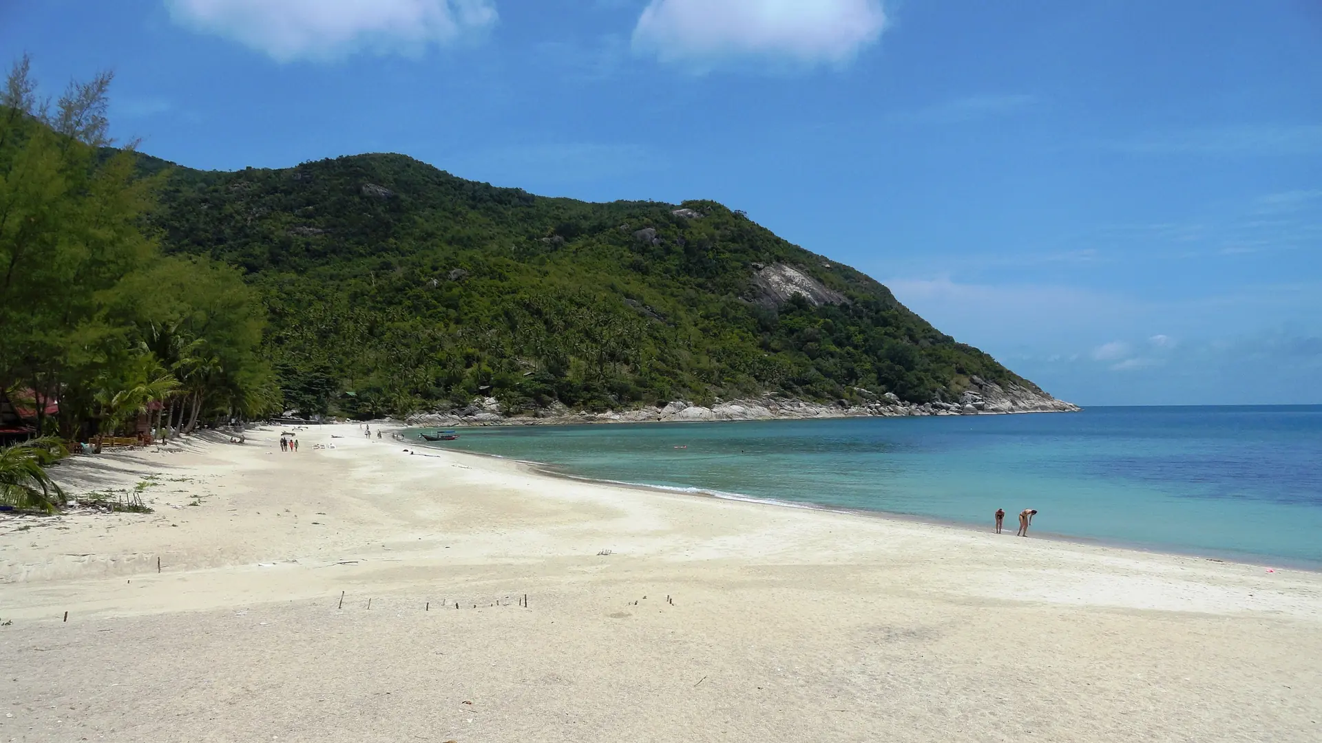 White sand and forested hills surrounding Bottle Beach on Koh Phangan