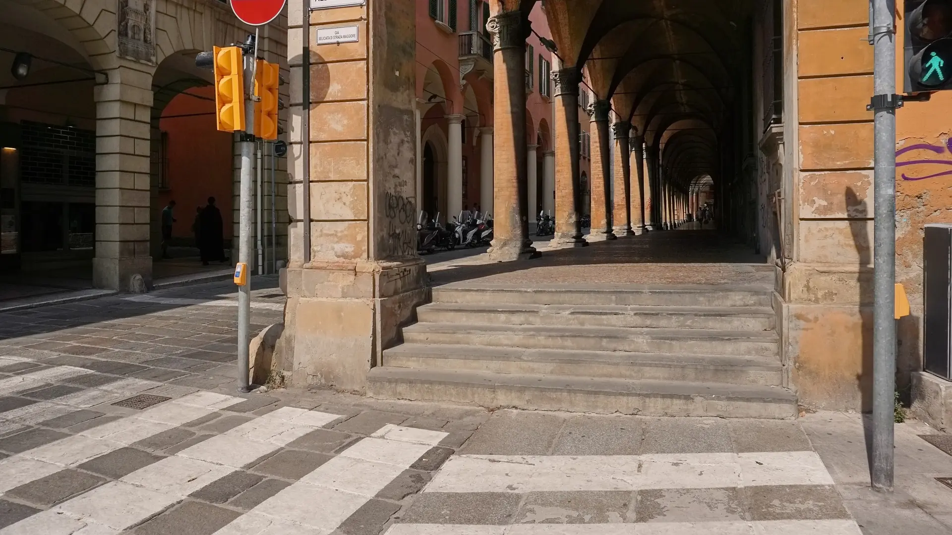 sunlit Bologna porticos opening onto Piazza Maggiore with warm terracotta architecture