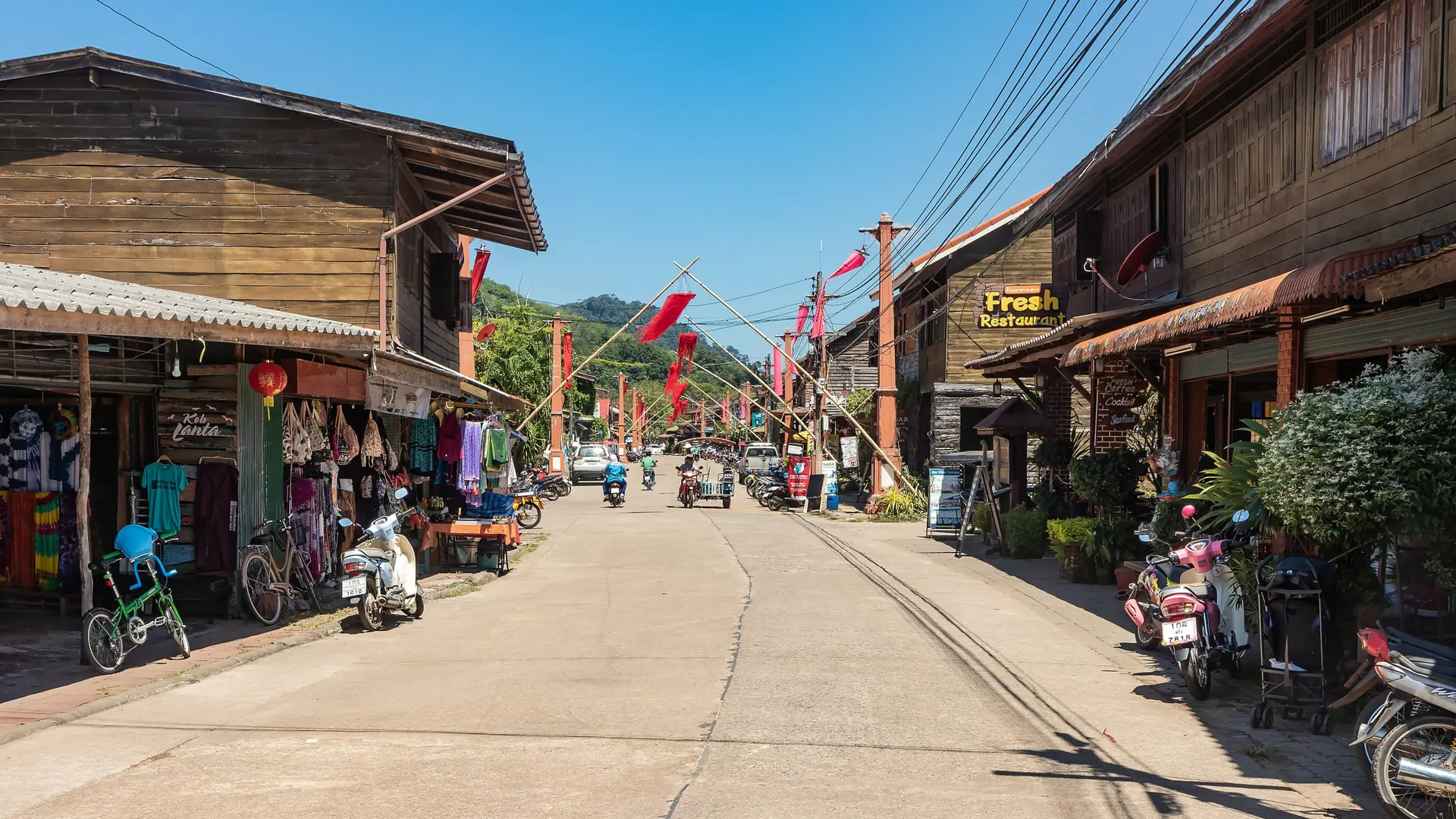 Wooden shops along the sunny main street of Lanta Old Town