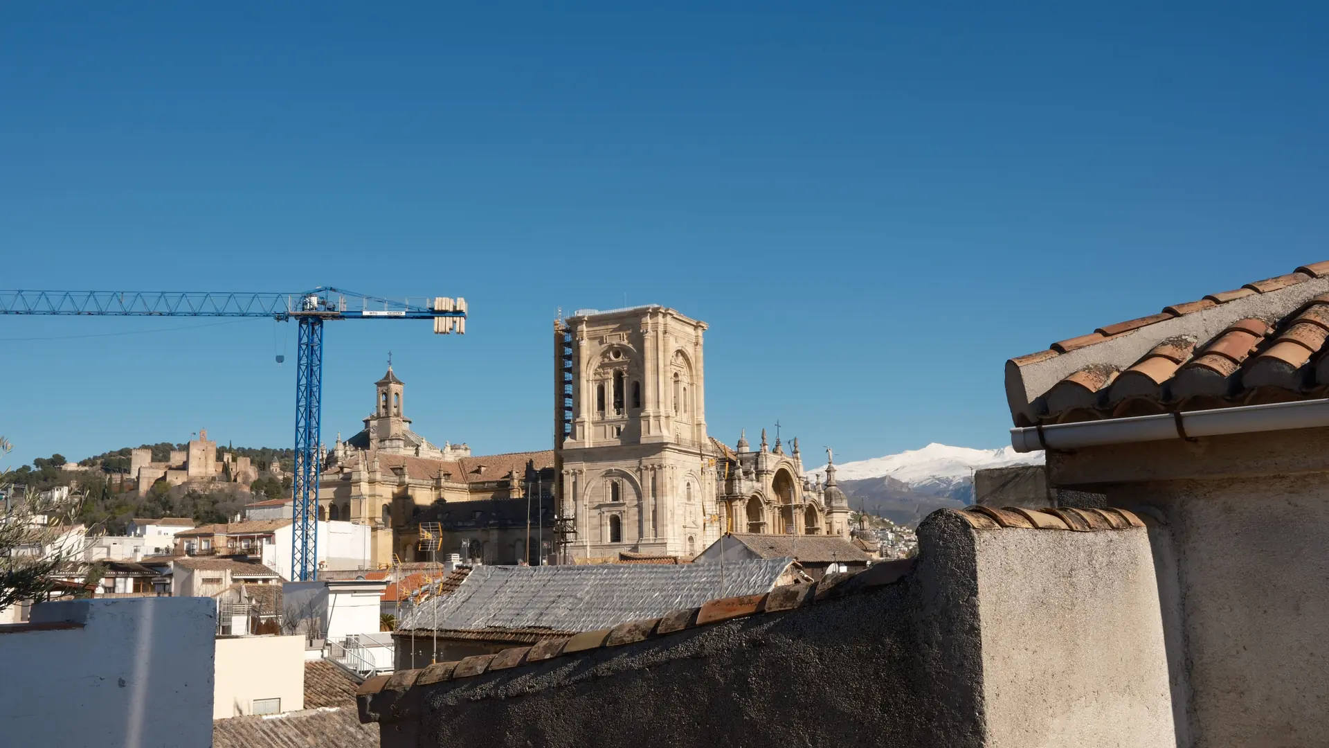 Granada Cathedral tower rising above the city centre rooftops