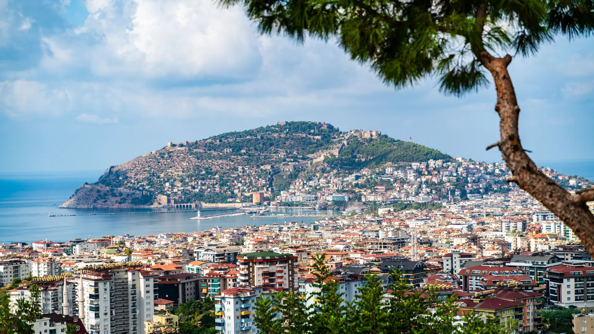 Alanya Castle hill and walled peninsula above the sunny Mediterranean city and harbour