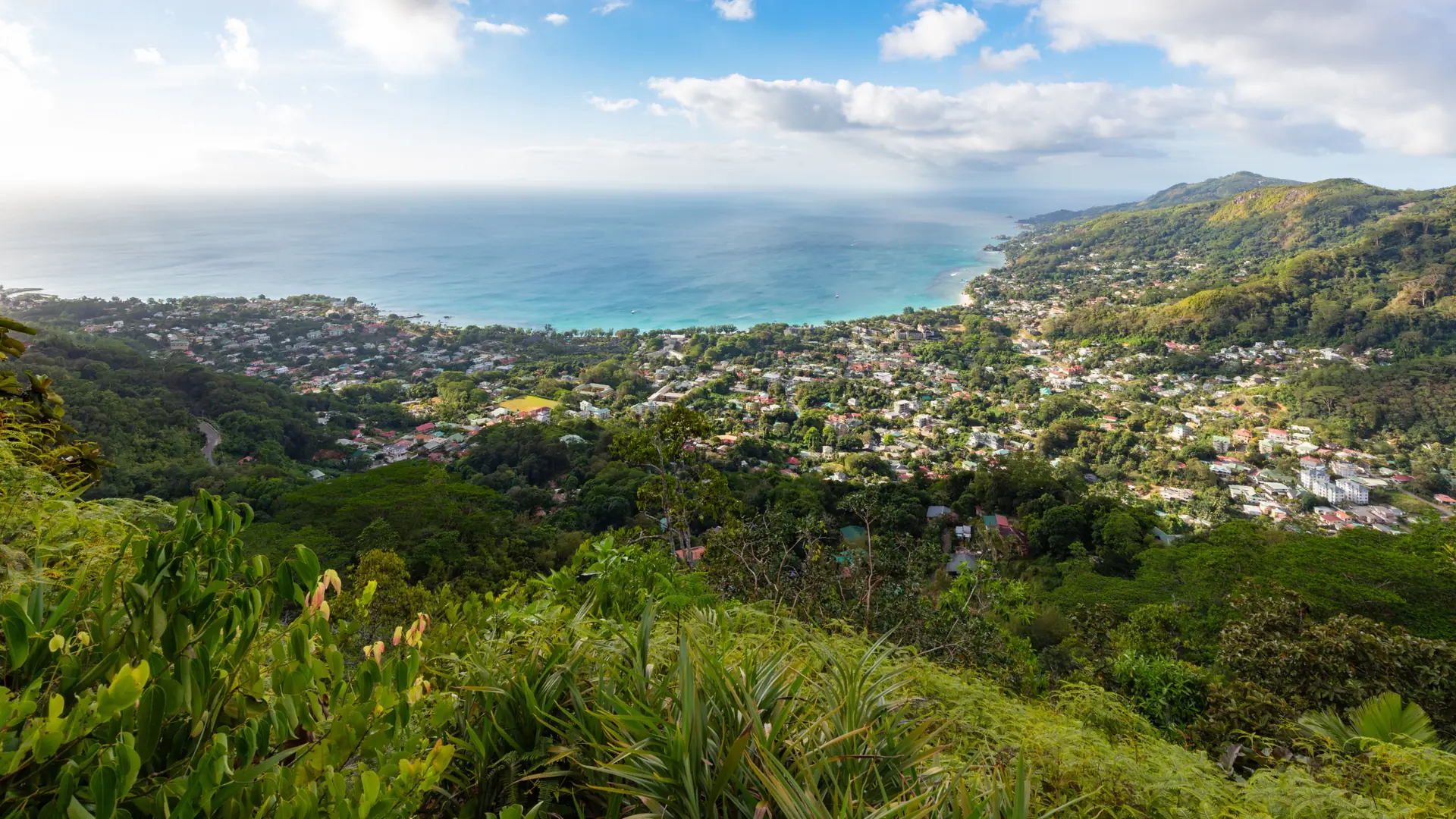Green hills and clustered rooftops above Beau Vallon bay