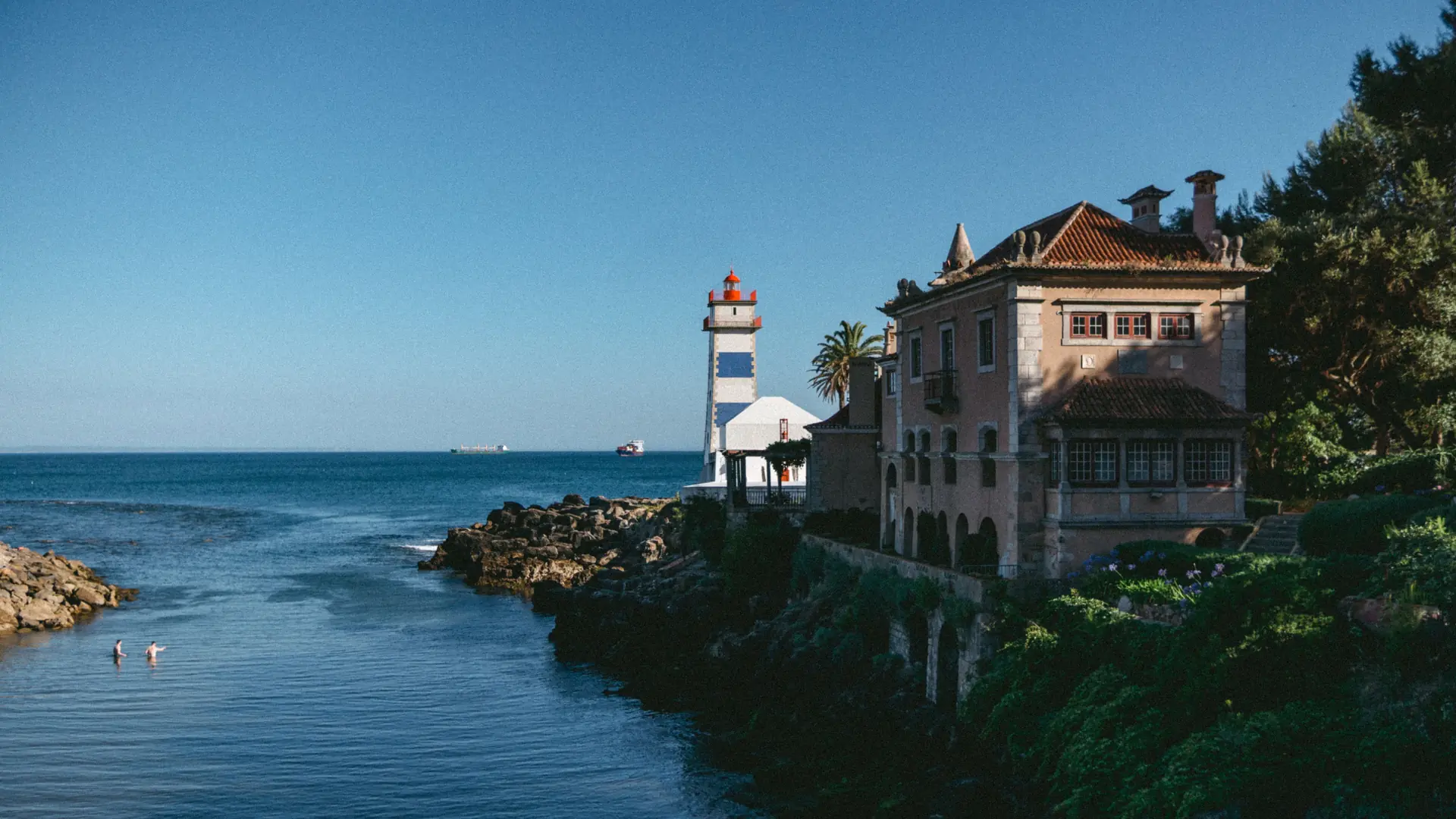 Santa Marta lighthouse and its white historic building on the Cascais waterfront