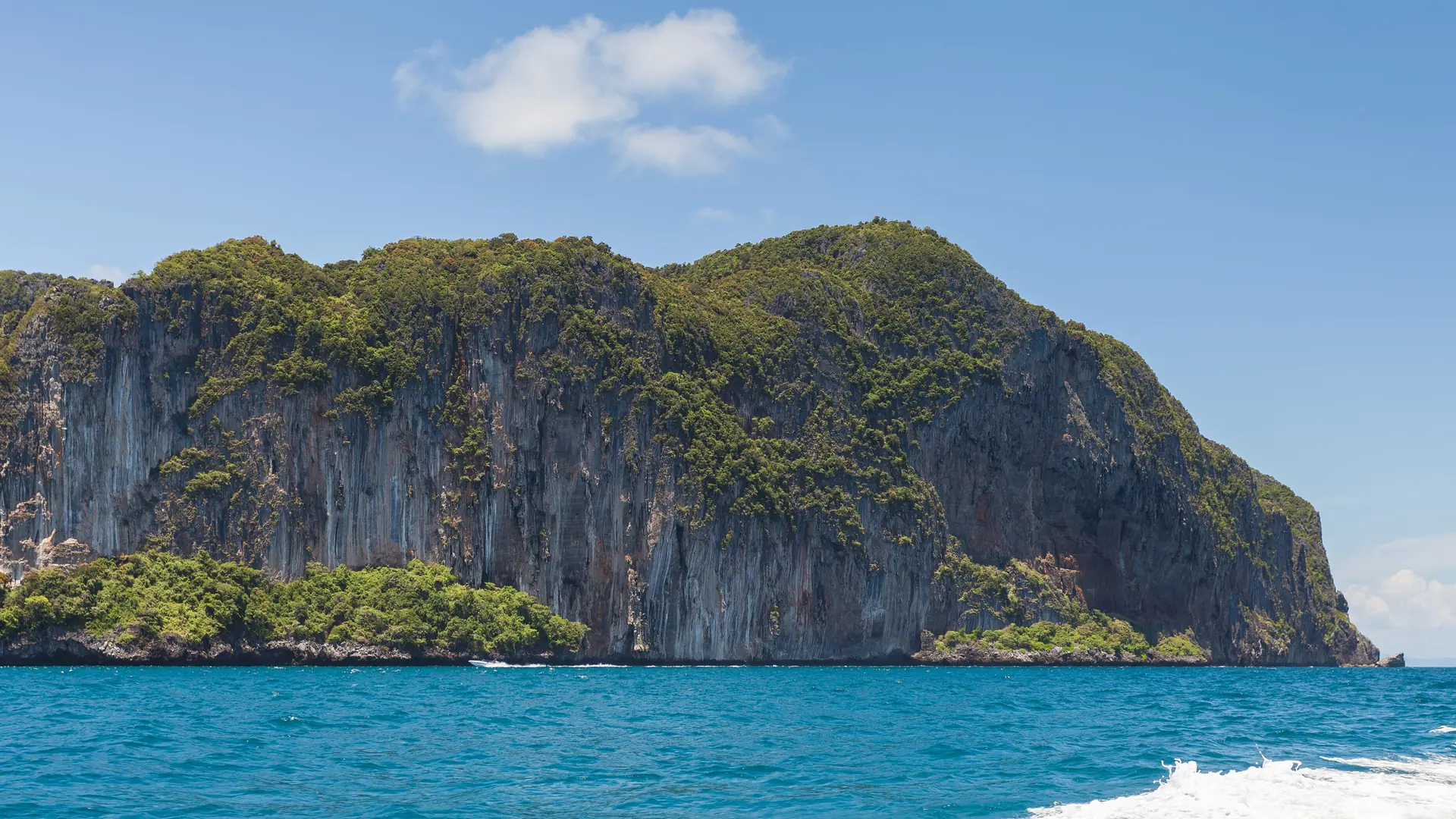 Quiet sand and forested slopes on northern Phi Phi Don