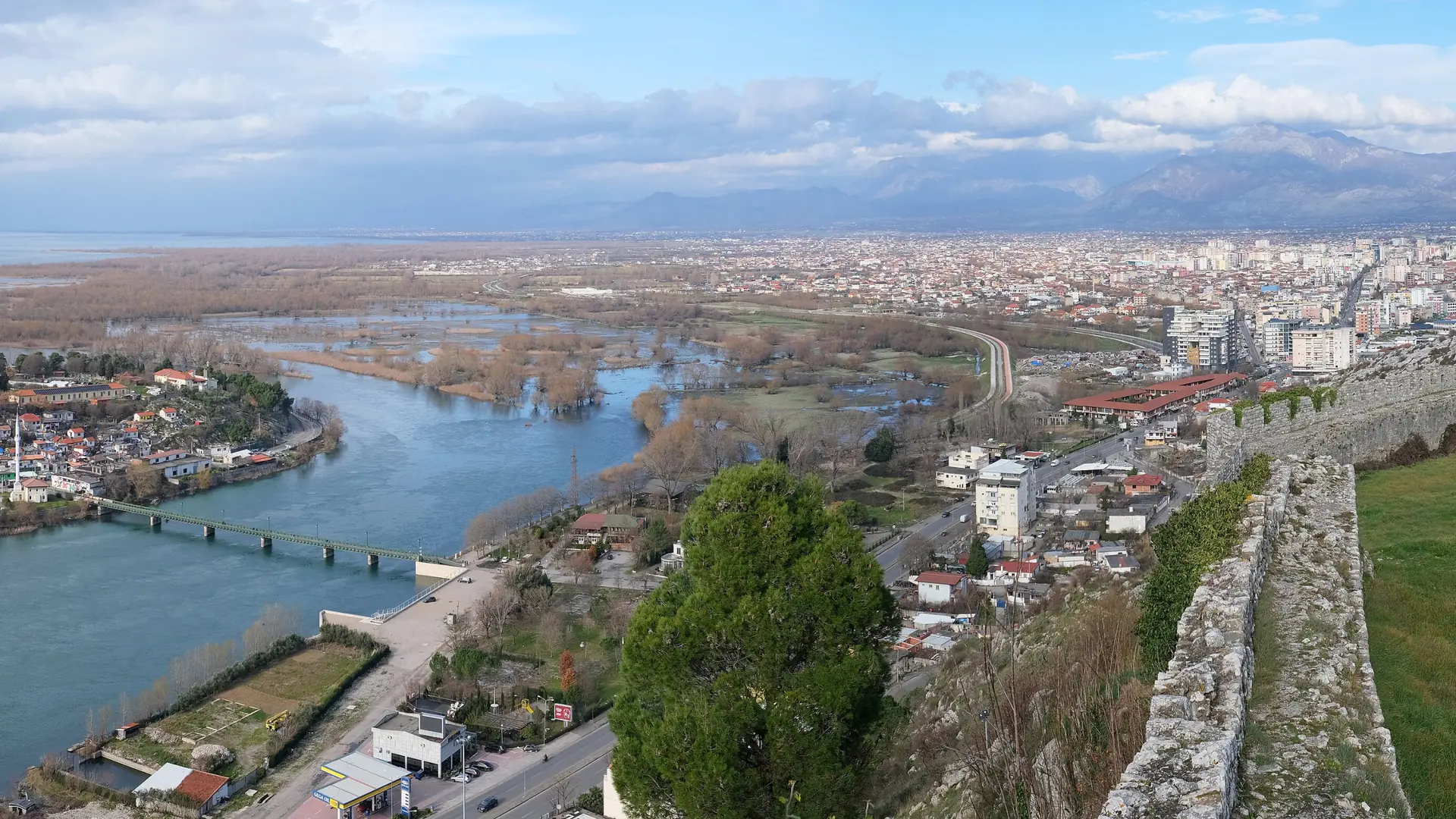 Shkodër and its rivers seen over a stretch of Rozafa's walls from the fortress on a bright day