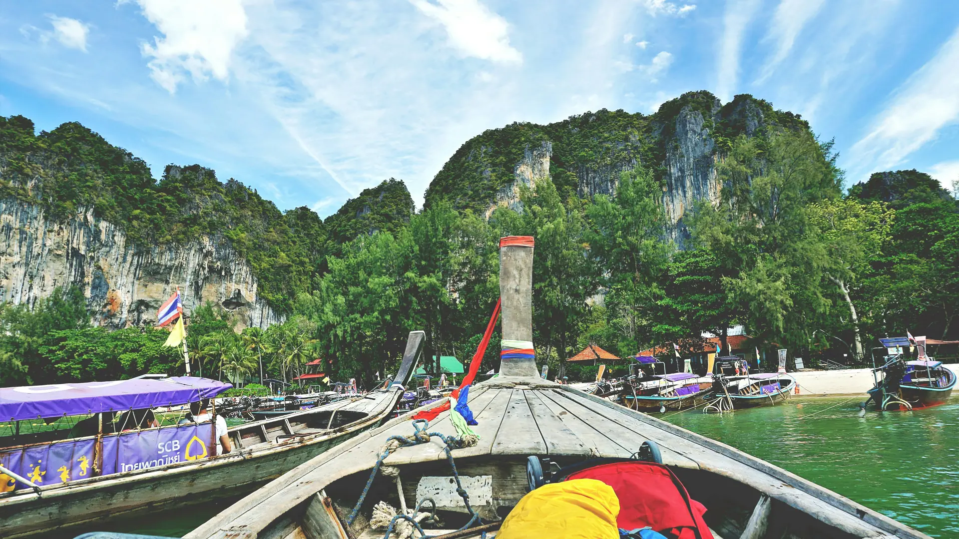 A long-tail boat crossing clear water off Ao Nang, Krabi