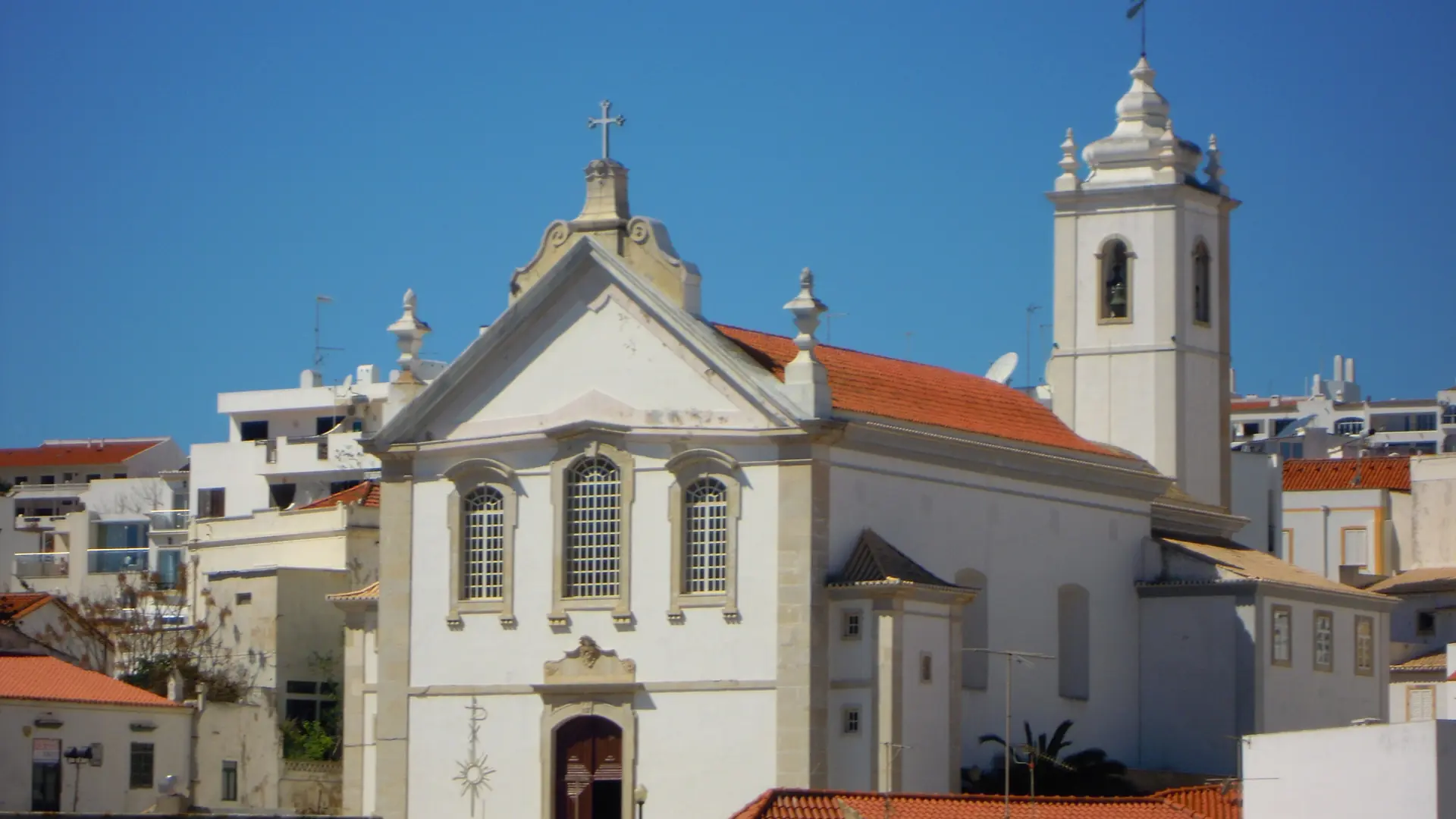 Igreja Matriz and its bell tower above whitewashed buildings in Albufeira Old Town