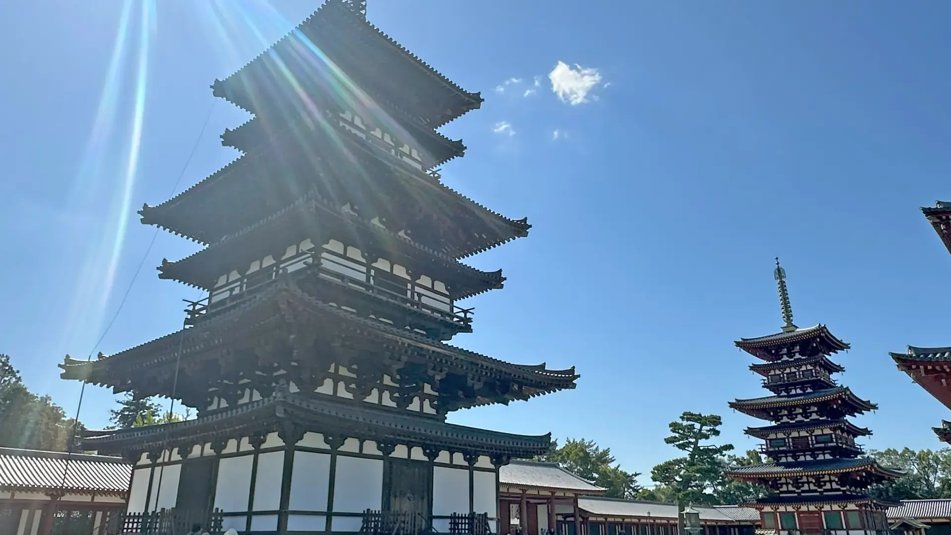 Yakushiji pagoda rising above green Nishinokyo temple grounds in sunshine