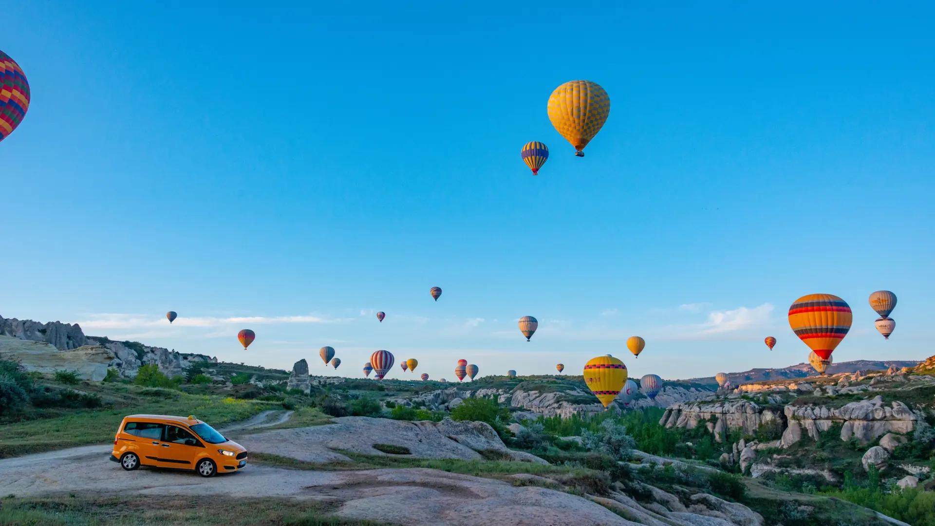 Colourful hot-air balloons floating above Cappadocia’s rock formations
