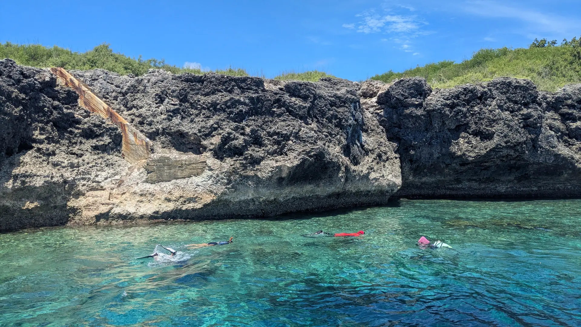 Snorkellers beside the limestone shore of Pescador Island near Moalboal