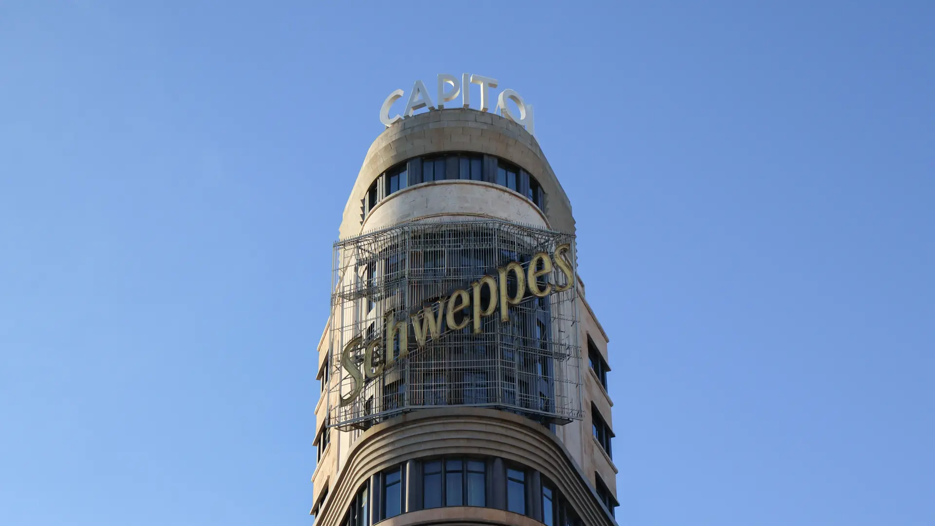 The rounded Capitol building on Gran Vía in Madrid with its Schweppes sign