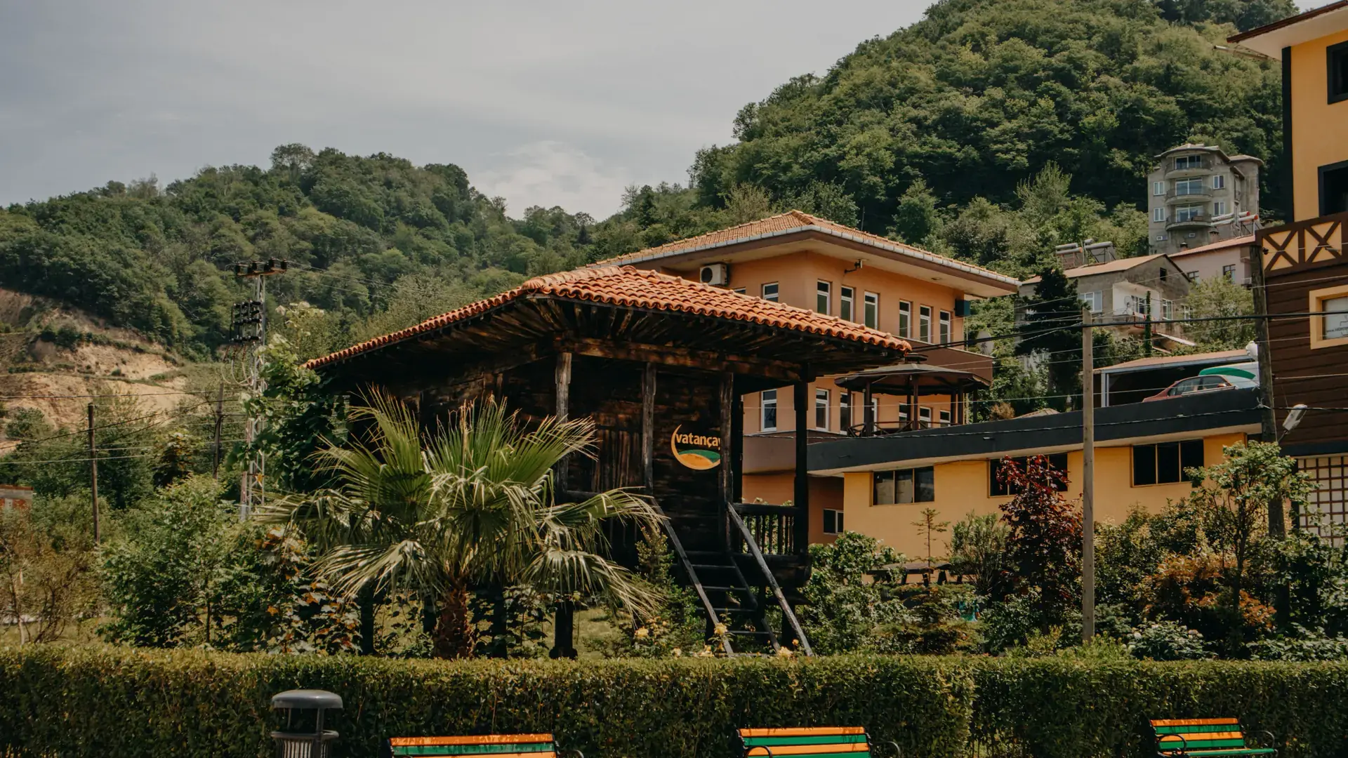 Traditional wooden architecture surrounded by lush green hills in Trabzon