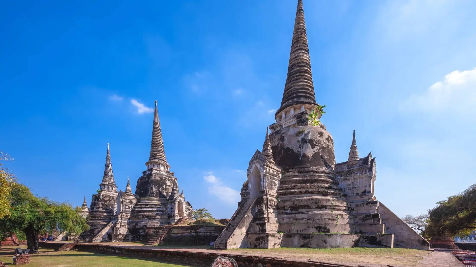 Sunlit chedis and brick ruins at Wat Phra Si Sanphet in Ayutthaya