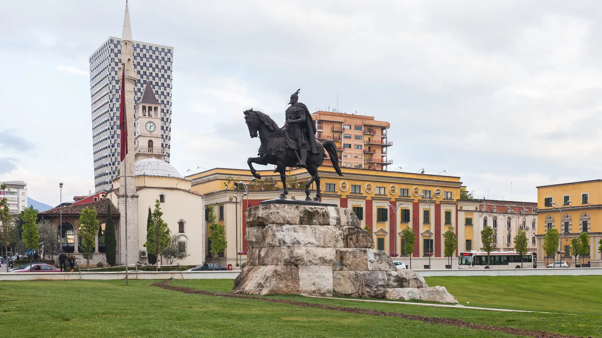 The Skanderbeg statue on Tirana's main square with the Et'hem Bey Mosque and clock tower behind