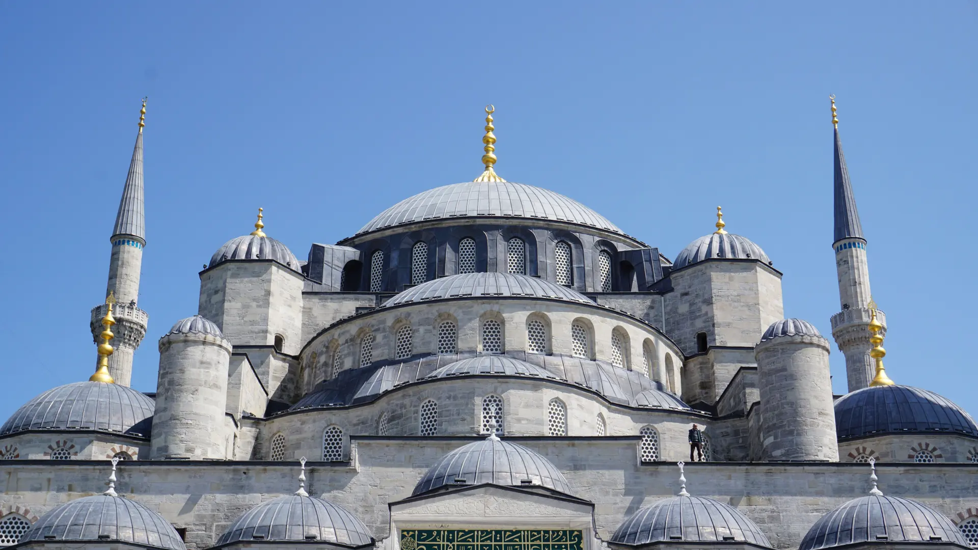 Blue Mosque domes and minarets rising unobstructed against a clear sunny Istanbul sky